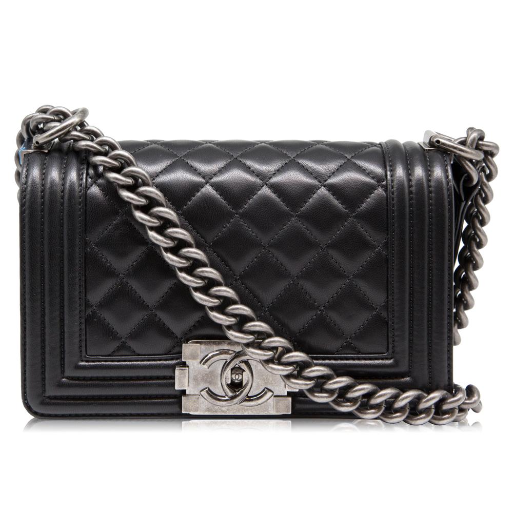 Crafted in smooth black lambskin leather, this Chanel Small boy bag is a modern spin on the Classic Flap bag and features the iconic quilted diamond pattern, logo push lock and top handle design. The Boy bag, which sky-rocketed to It-bag status