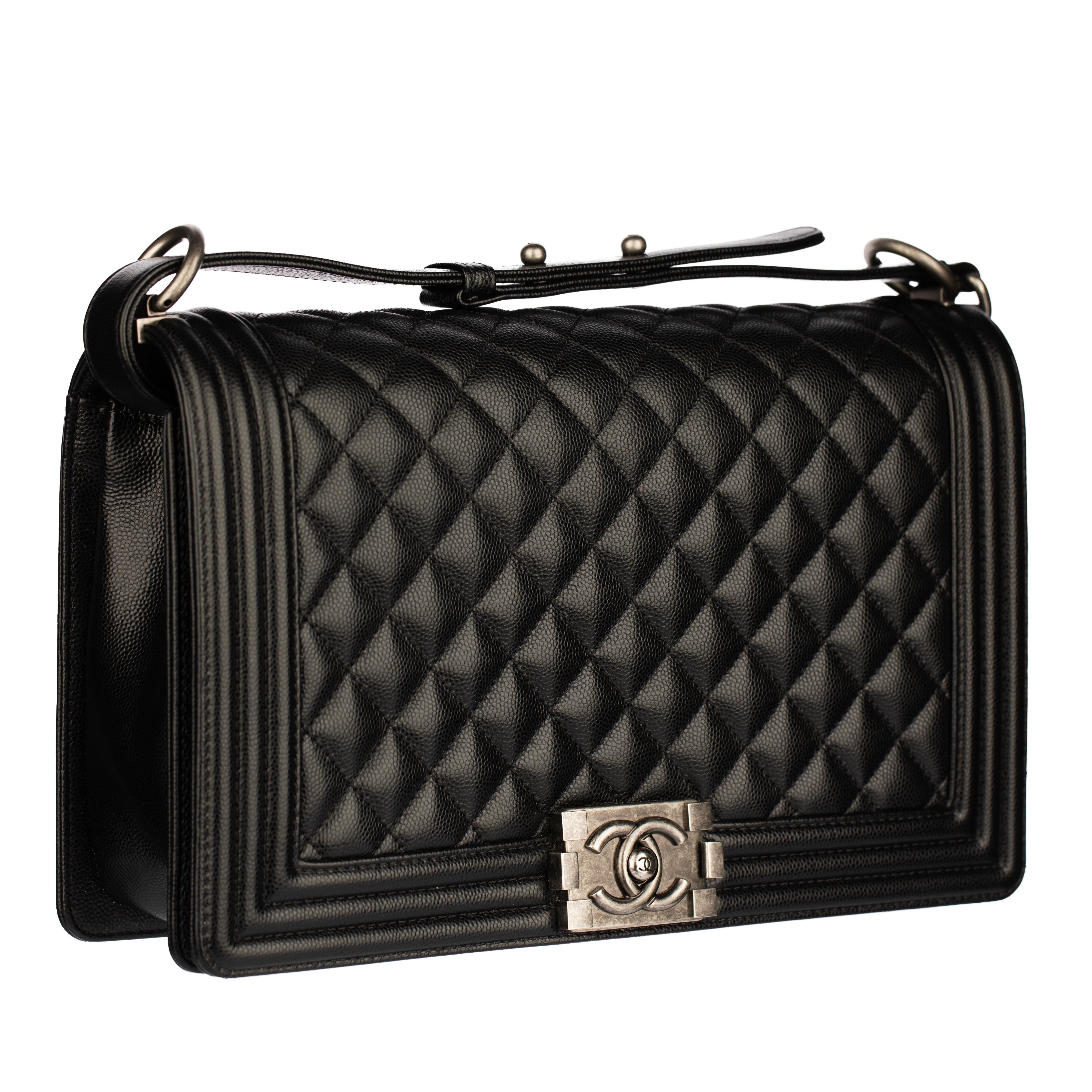 Discover timeless Parisian style with this Chanel Boy Bag in quilted black caviar leather. Accented with antiqued silver-tone hardware and finished with the iconic CC push-lock clasp, this structured flap bag exudes modern elegance and