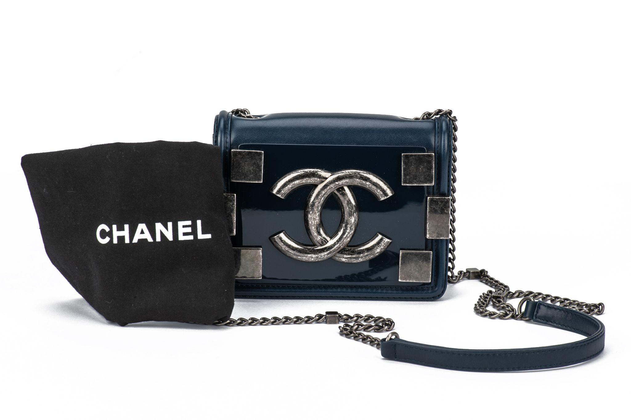 Chanel Boy Brick Flap Bag made of plexiglass and lambskin leather. The interior features red canvas. Collection #18, 2013/2014. Shoulder drop 23.5. The bag is in excellent condition and comes with the original dustcover, the hologram and the id card.