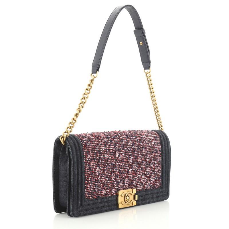 This Chanel Boy Clutch Shoulder Bag Tweed Medium, crafted from blue and red tweed, features chain link strap with shoulder pad and aged gold-tone hardware. Its CC Boy push-lock closure opens to a blue fabric interior with slip pocket. Hologram