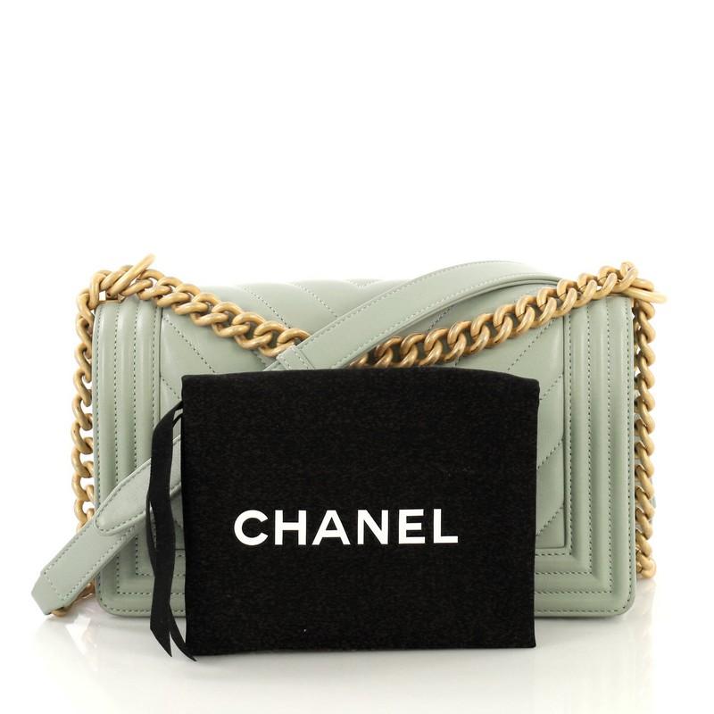 This Chanel Boy Flap Bag Chevron Lambskin Old Medium, crafted in pale green chevron lambskin, features chain link strap with leather pad and matte gold-tone hardware. Its Boy push-lock closure opens to a pale green fabric interior with slip pocket.