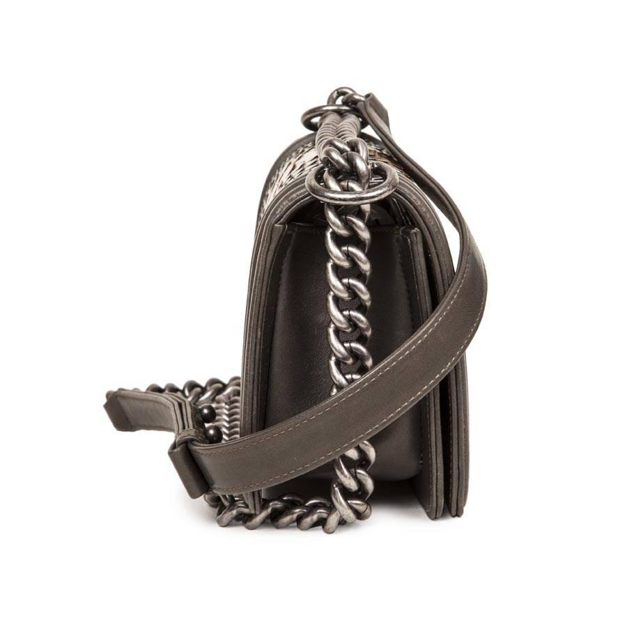 Chanel 'Boy' flap bag in python shades green bronze and gold and khaki green smooth lamb leather. Aged silver plated hardware. Closure with clip 'CC'. 
Leather interior of the same shade and plated slot. 
Worn shoulder or crossover with adjustable