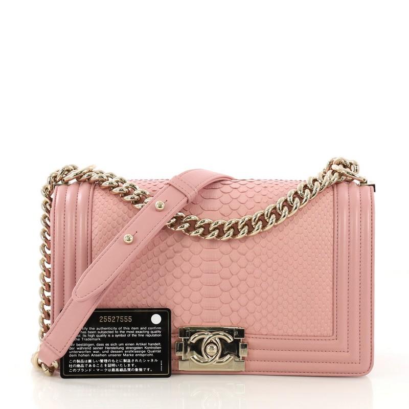 This Chanel Boy Flap Bag Python Old Medium, crafted in genuine pink python, features chain link strap with leather pad and gold-tone hardware. Its boy push-lock closure opens to a pink leather interior with slip pocket. Hologram sticker reads: