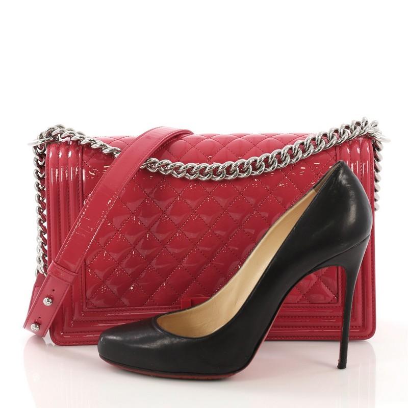 This Chanel Boy Flap Bag Quilted Plexiglass Patent New Medium, crafted from pink quilted patent leather, features a chunky chain link strap with shoulder pad, frontal plexiglass CC Boy square press-lock and silver-tone hardware. Its press-lock