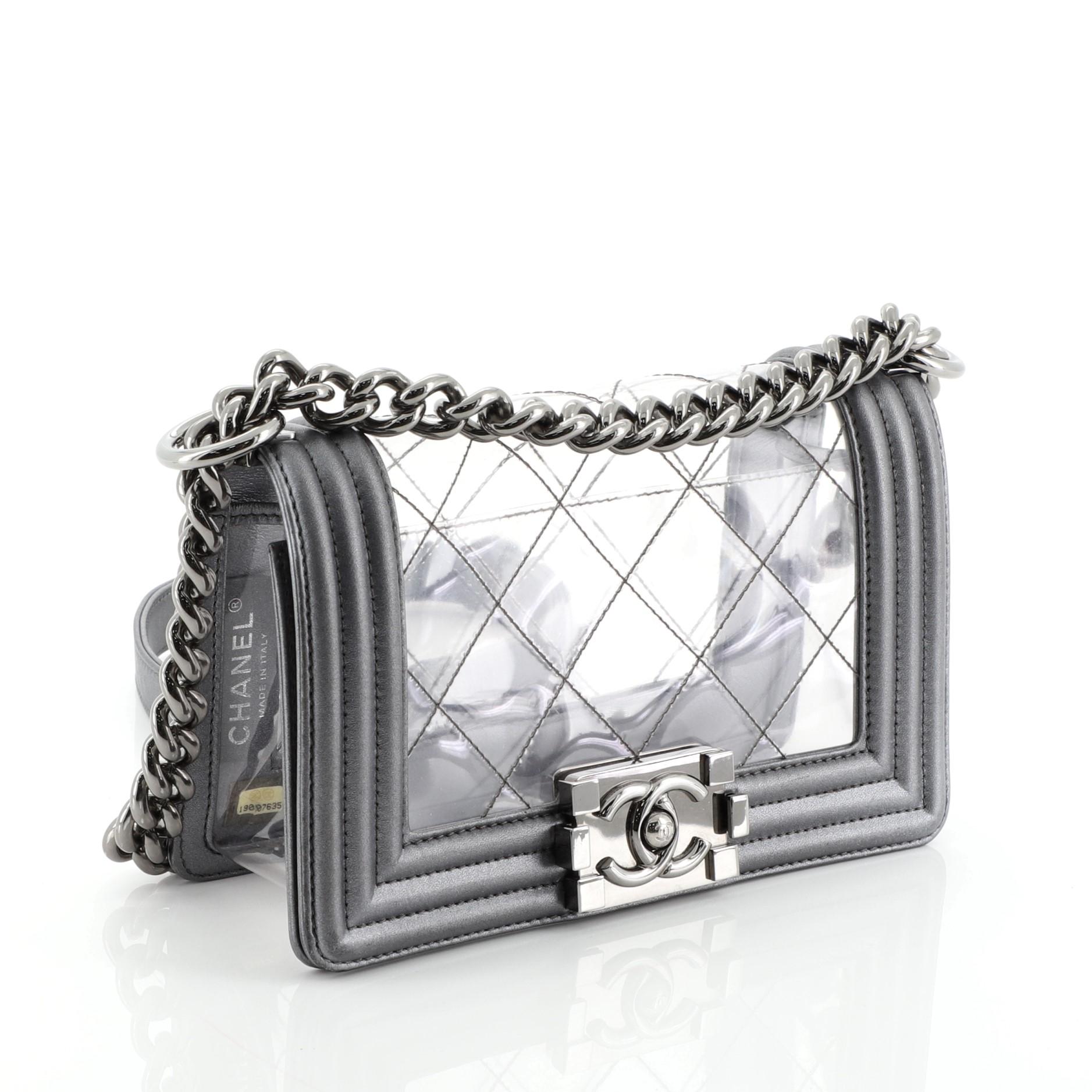 This Chanel Boy Flap Bag Quilted PVC and Calfskin Small, crafted in quilted clear PVC and gray leather, features chain link strap with shoulder pad and gunmetal-tone hardware. Its CC Boy logo push-lock closure opens to a clear PVC interior. Hologram