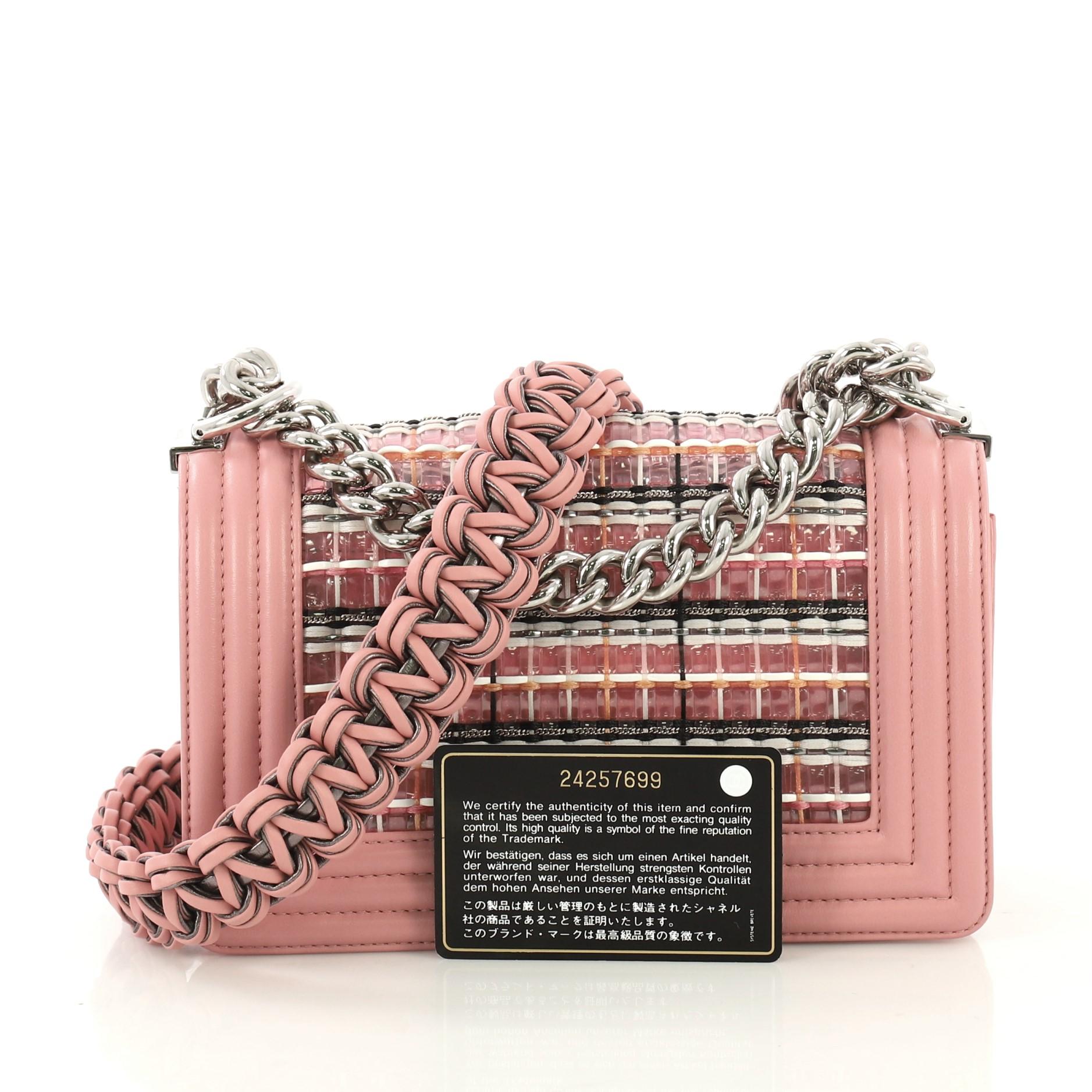 This Chanel Boy Flap Bag Woven PVC with Lambskin Small, crafted in multicolor woven PVC with pink lambskin leather, features chain strap with leather pad, and silver-tone hardware. Its CC boy push-lock closure opens to a pink leather interior.