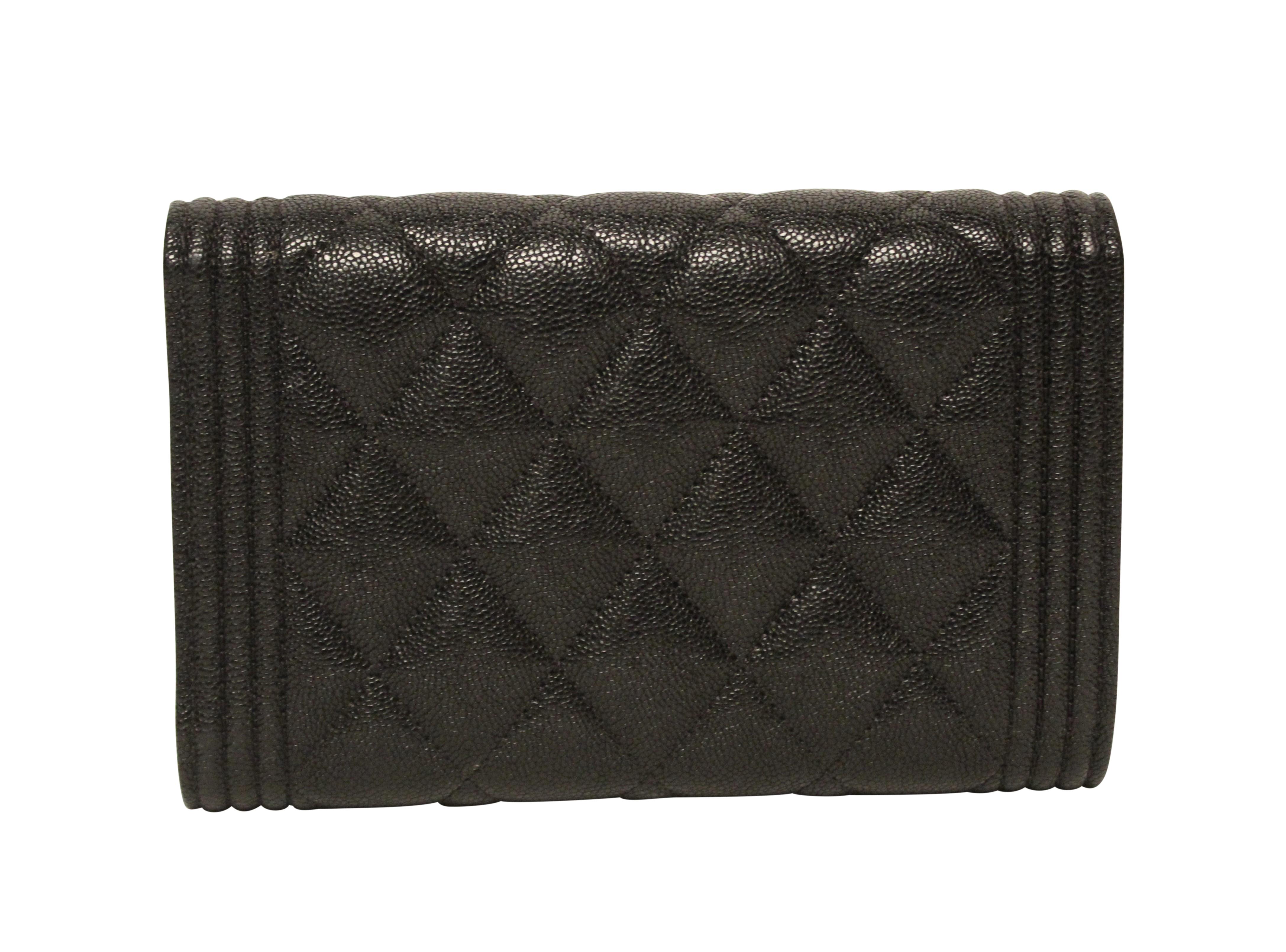 Pristine CHANEL medium Boy Flap wallet in grained calfskin, and soft gold toned metal hardware. This wallet features iconic Boy Bag style linear border, iconic CHANEL quilting, interior zip pocket, notes comparment and idividual card slots.