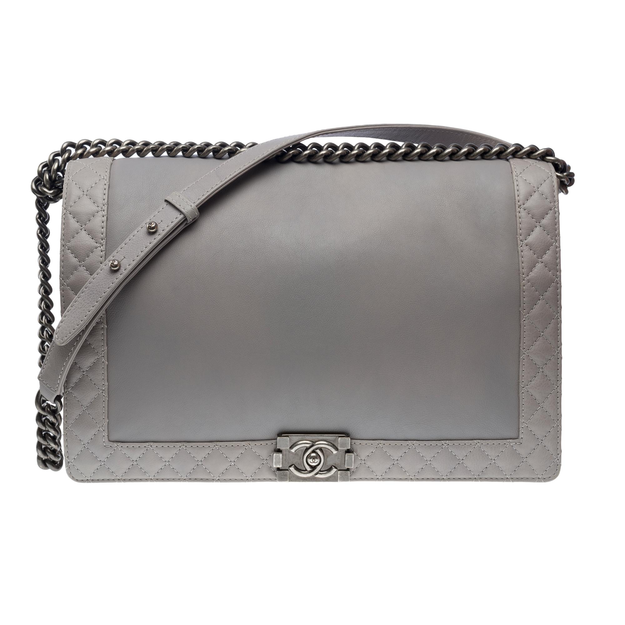 Rare​ ​Chanel​ ​Boy​ ​Reverso​ ​Maxi​ ​Boy​ ​shoulder​ ​bag​ ​in​ ​Grey​ ​soft​ ​calf​ ​leather​ ​partially​ ​quilted​ ​,​ ​ruthenium​ ​metal​ ​trim,​ ​an​ ​adjustable​ ​ruthenium​ ​metal​ ​chain​ ​handle​ ​for​ ​shoulder​ ​or​ ​crossbody​