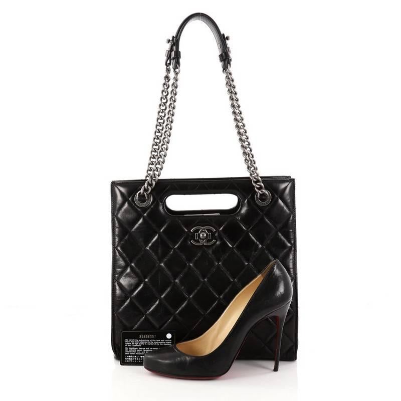 This authentic Chanel Boy Shopper Quilted Glazed Calfskin Small from 2017 is a functional and casual everyday design. Crafted from black glazed calfskin leather, this structured tote features Chanel's signature diamond quilting, dual chain link