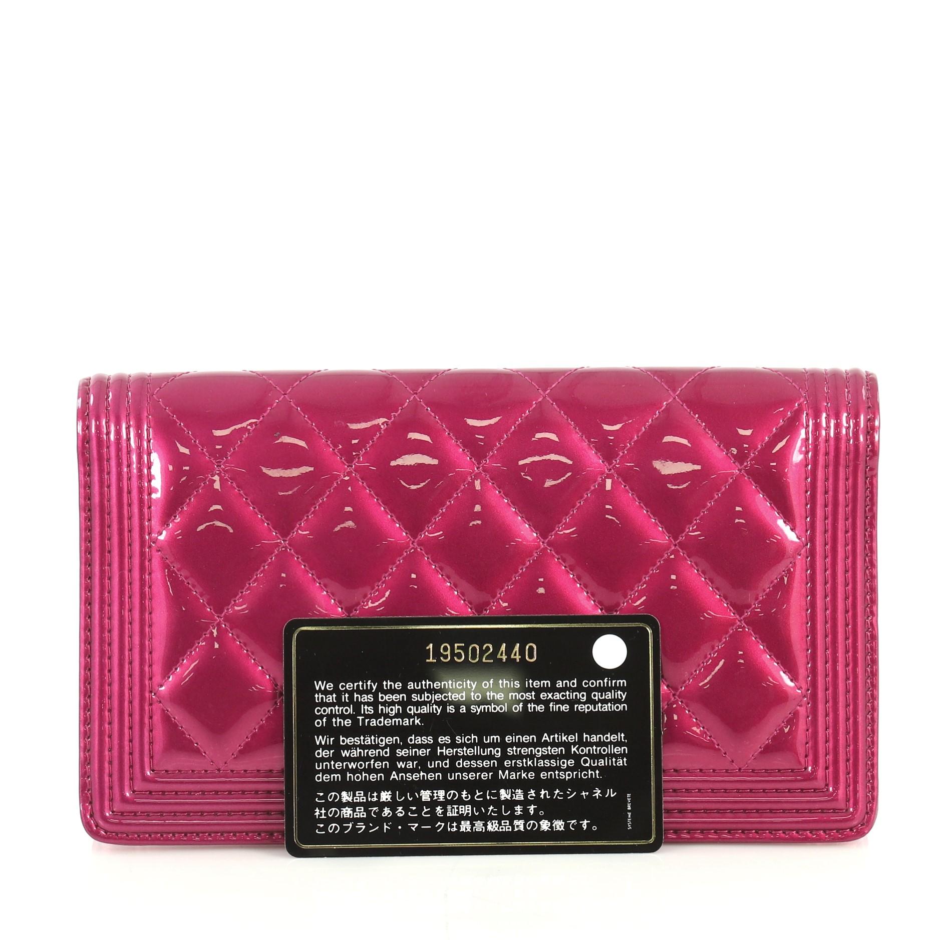 This Chanel Boy Yen Wallet Quilted Patent, crafted in pink quilted patent, features CC boy logo and gunmetal-tone hardware. It opens to a pink leather interior with multiple card slots and slip and zip pockets. Hologram sticker reads: 19502440.
