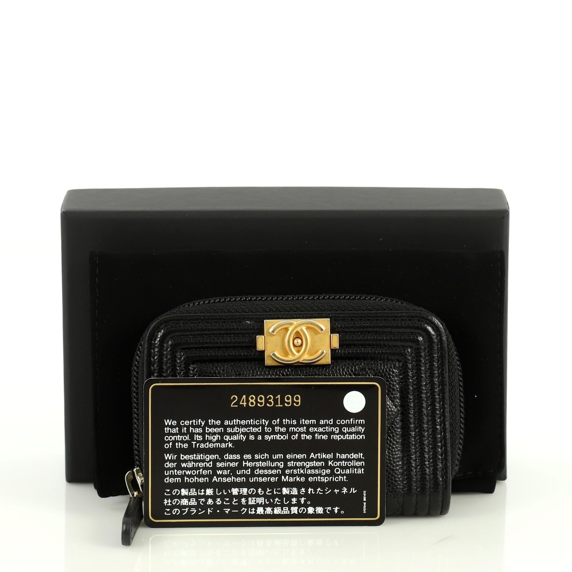 This Chanel Boy Zip Coin Purse Quilted Caviar Small, crafted from black quilted caviar leather, features CC Boy logo and gold-tone hardware. Its zip closure opens to a black fabric interior divided into three compartments. Hologram sticker reads: