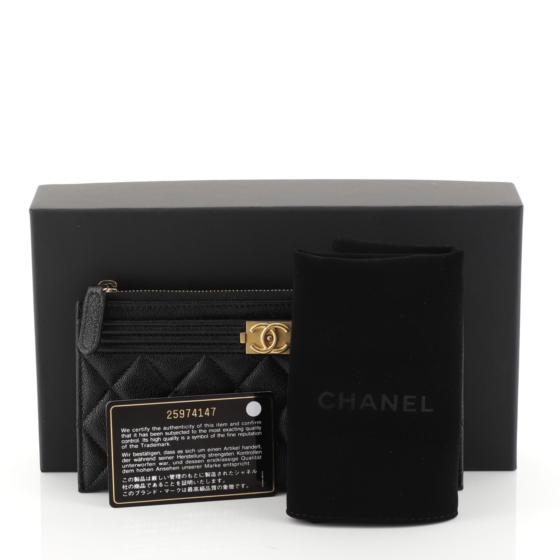 This Chanel Boy Zip Pouch Quilted Caviar Long, crafted from black quilted caviar leather, features CC boy logo and matte gold-tone hardware. Its zip closure opens to a black fabric interior. Hologram sticker reads: 25974147. 

Estimated Retail