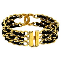 CHANEL BRACELET, iconic CC, 3 strand chain interwoven with leather, 24k goldp.