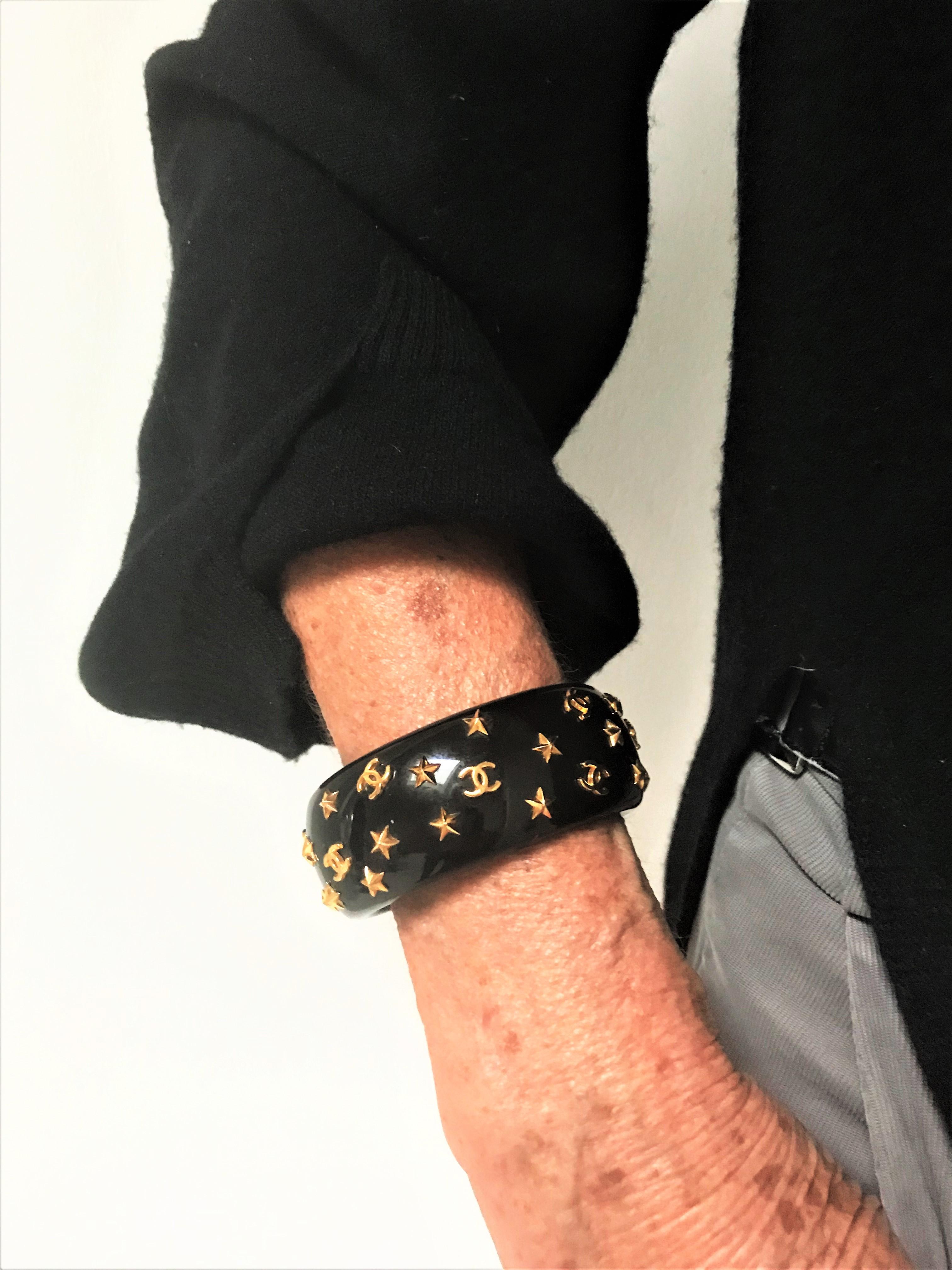 Chanel open bracelet, molded black acrylic signed 95 CC P with gold stars and CC 2