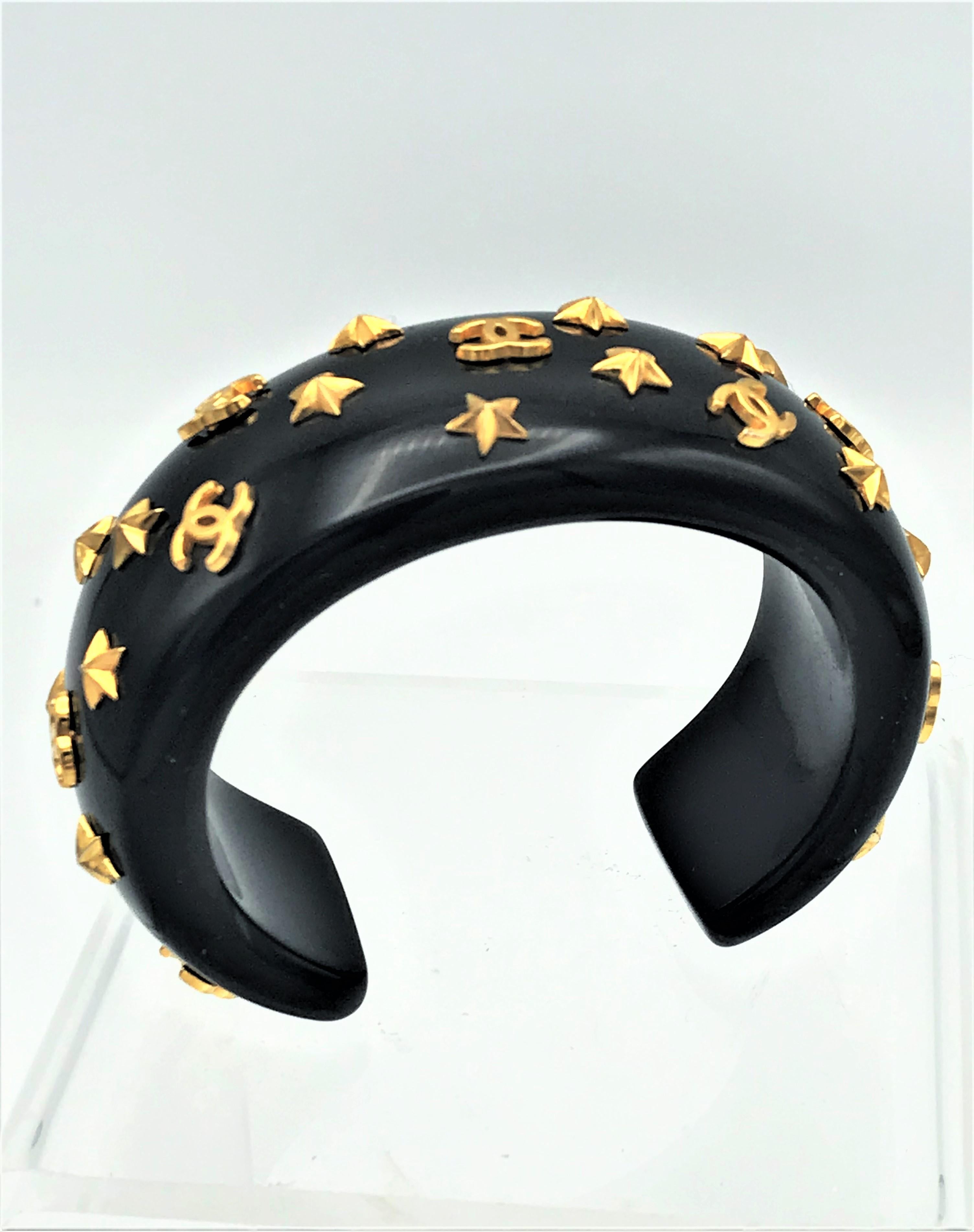 Artisan Chanel open bracelet, molded black acrylic signed 95 CC P with gold stars and CC