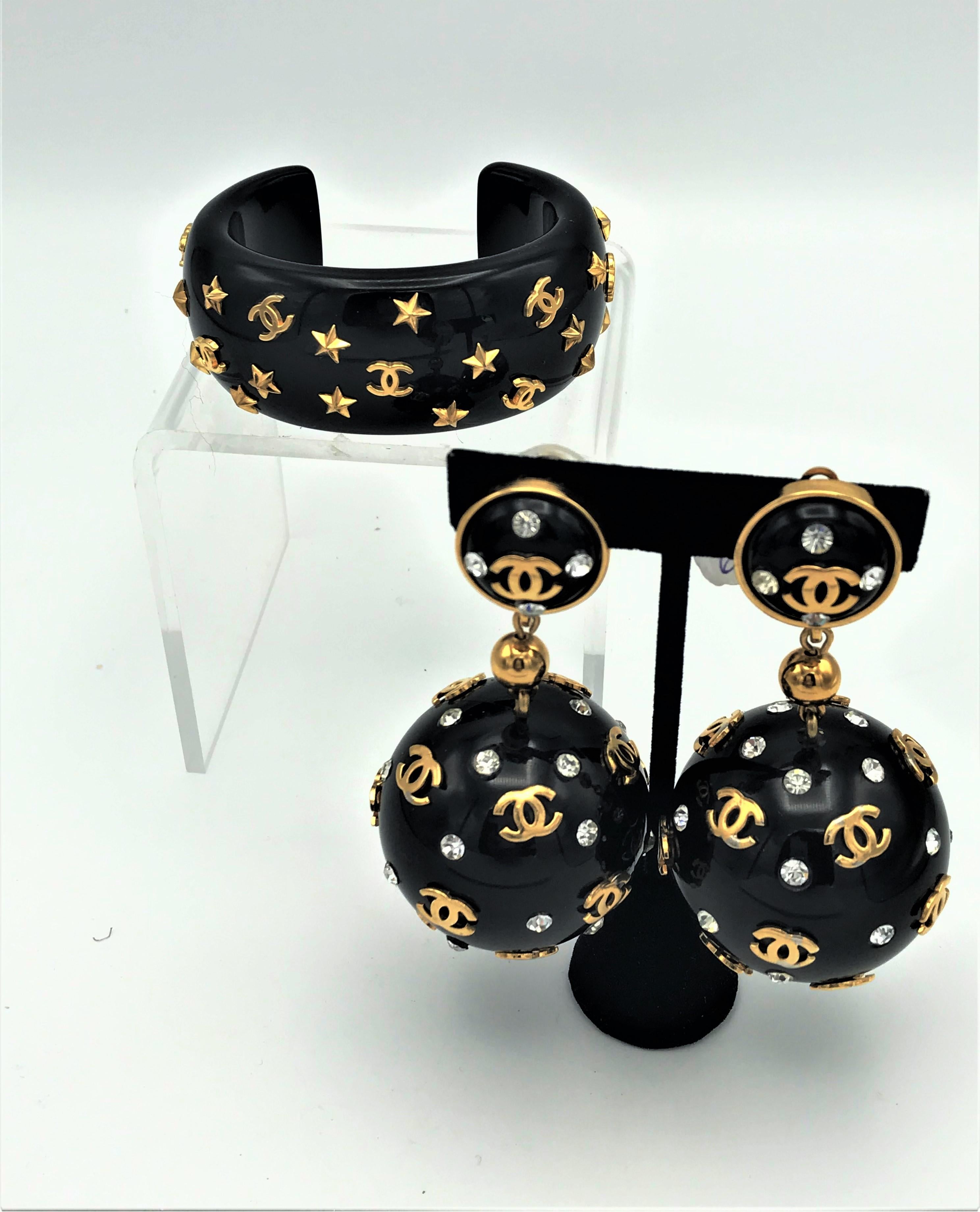 Women's Chanel open bracelet, molded black acrylic signed 95 CC P with gold stars and CC