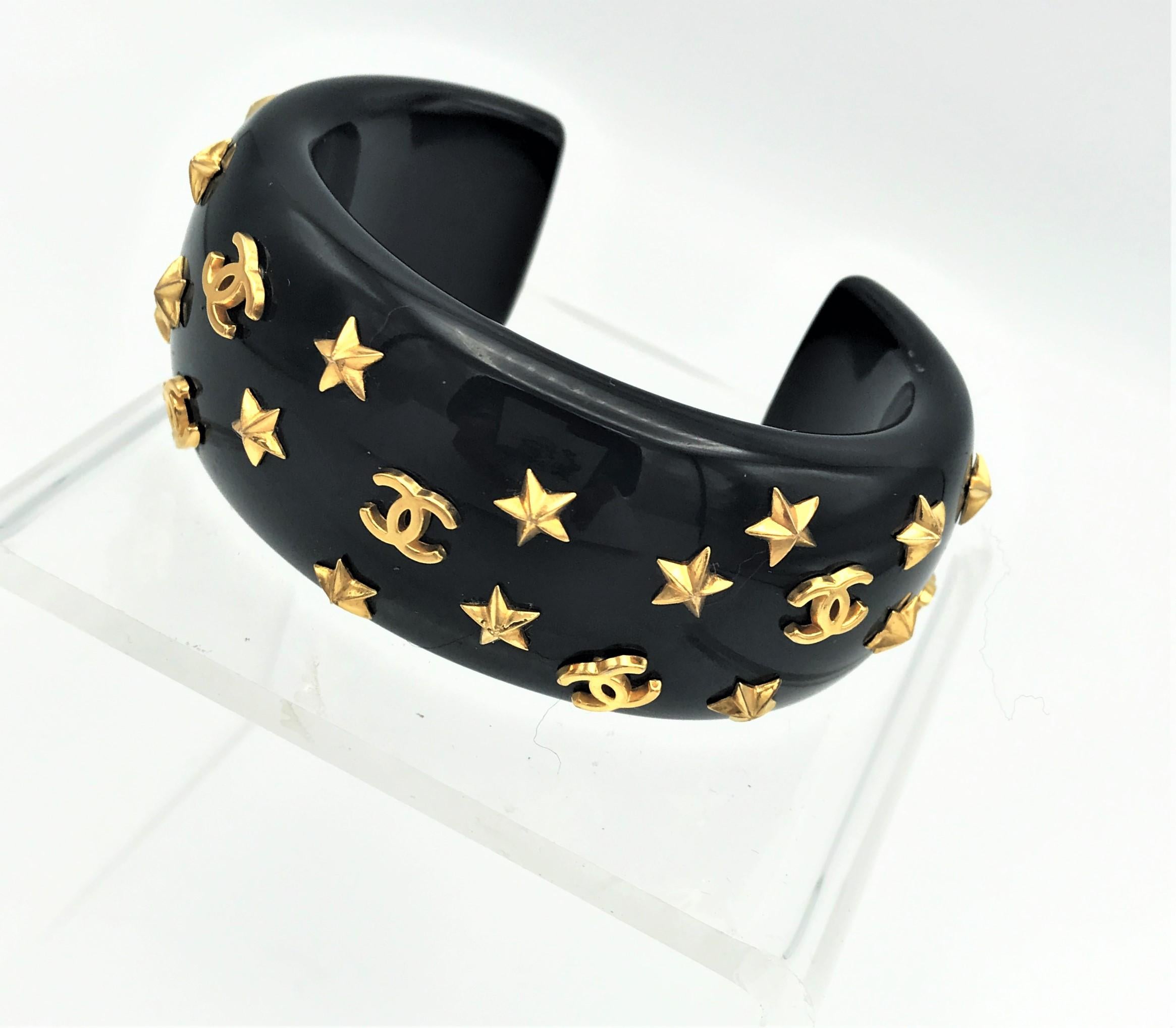 Chanel open bracelet, molded black acrylic signed 95 CC P with gold stars and CC 1