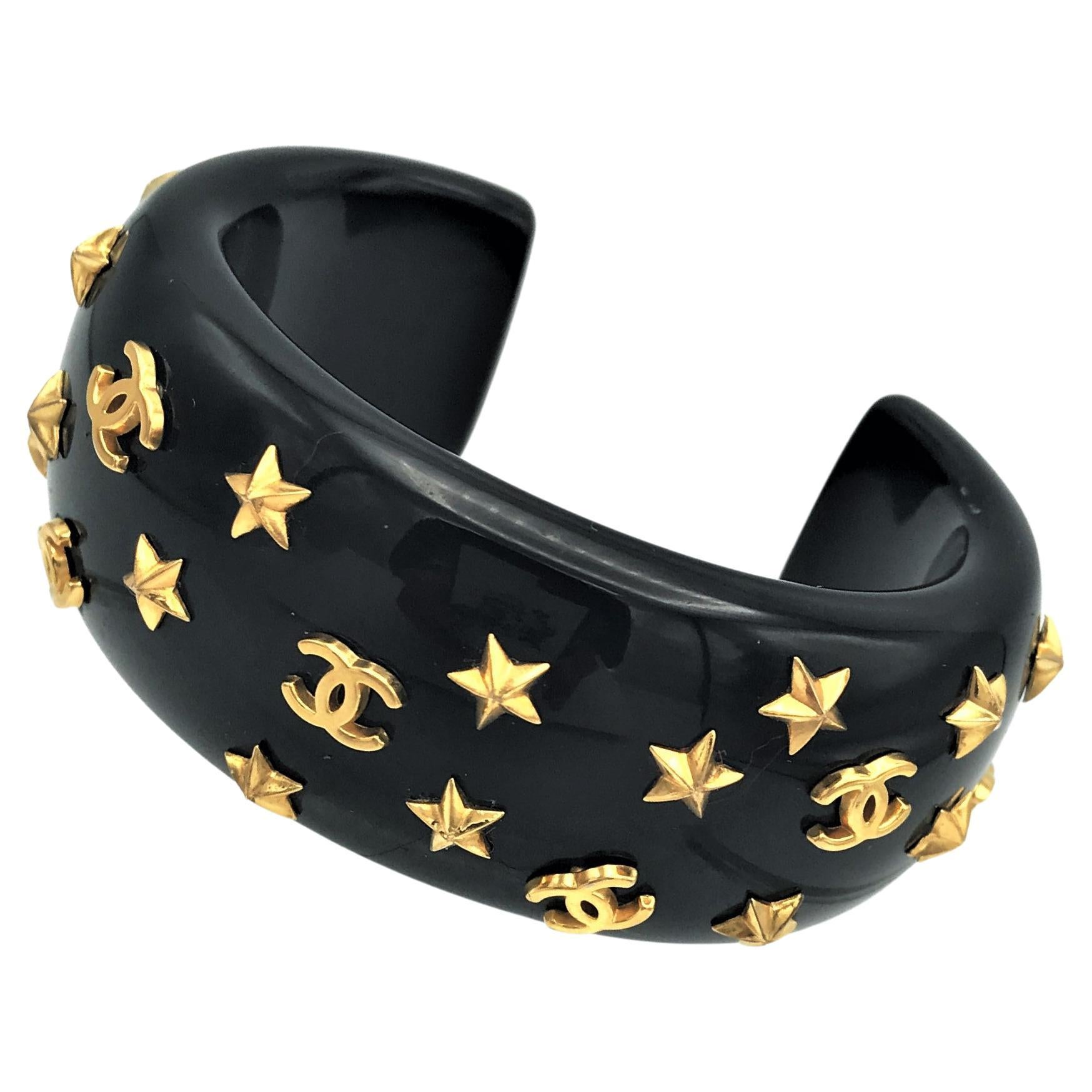 Chanel open bracelet, molded black acrylic signed 95 CC P with gold stars and CC
