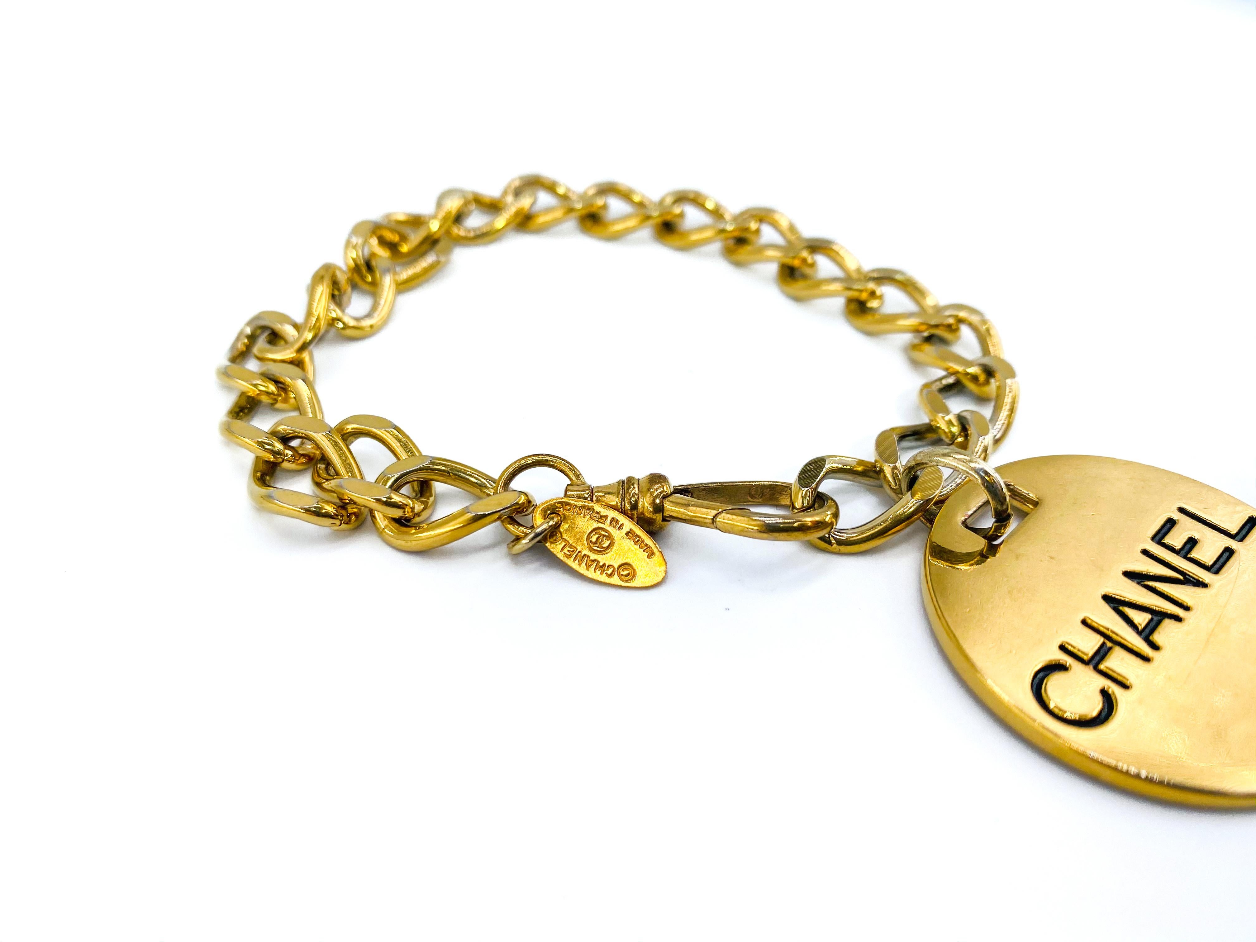 Chanel Vintage 1980s Bracelet

Details
-Gold plated metal 
-Made in the early 80s
-Chunky chain with adjustable clasp
-Large medallion charm embossed with Chanel on one side and Paris on the other

Size & Fit
Chain measures 7.5 inches but the clasp