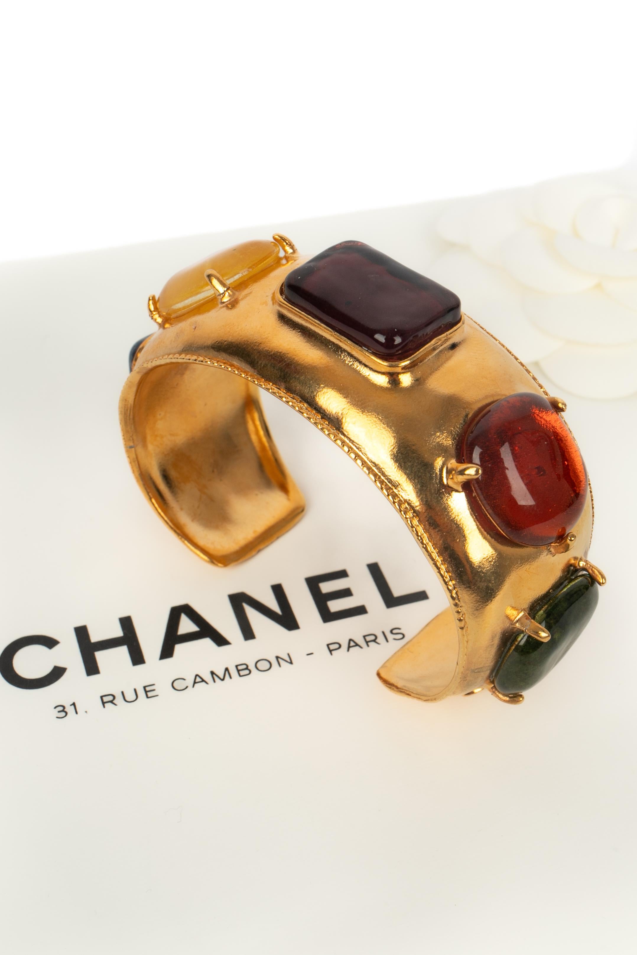 Chanel - (Made in France) Bracciale in metallo dorato con pasta di vetro multicolore. Collezione Autunno-Inverno 1997 sotto la direzione artistica di Karl Lagerfeld.

Condizioni:
Ottime condizioni

Dimensioni:
Lunghezza: 14,5 cm - Apertura: 3