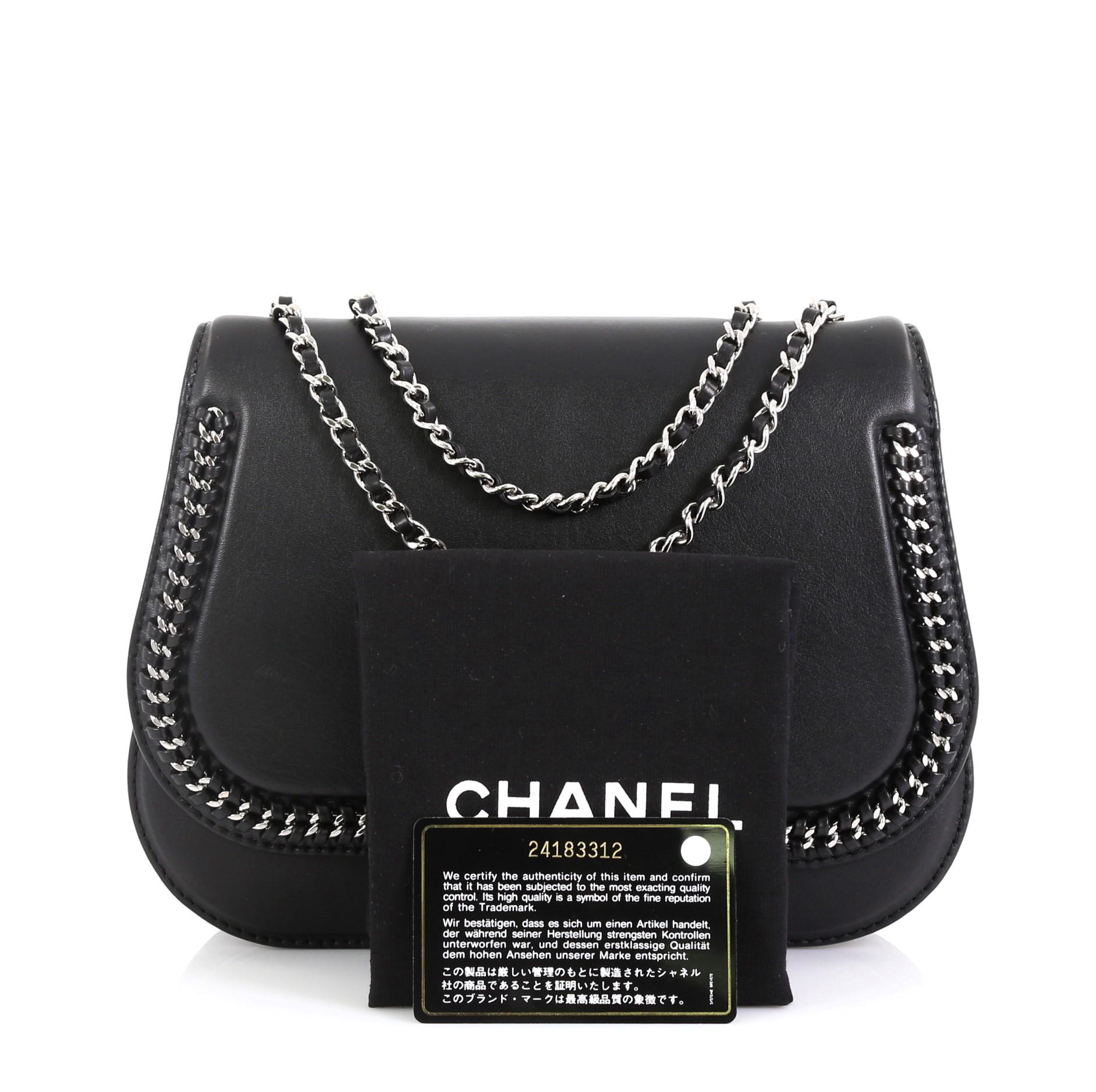 This Chanel Braided Chic Flap Bag Calfskin Small, crafted from black calfskin leather, features woven-in leather chain straps, braided detailing and silver-tone hardware. Its CC turn-lock closure opens to a black fabric interior divided into two