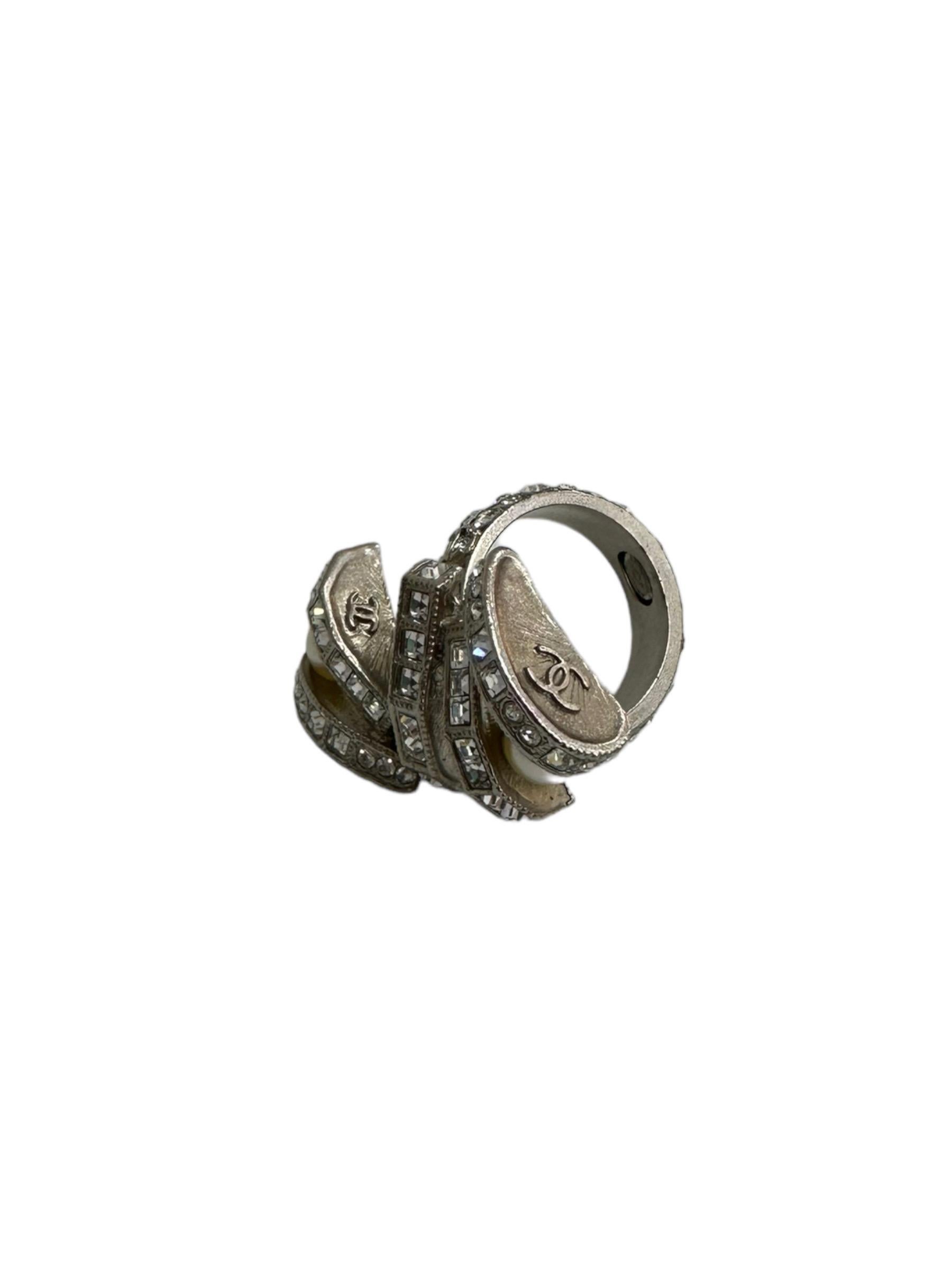Chanel signed ring, made of silver metal, covered with rhinestones and small pearls. It seems in perfect conditions.

