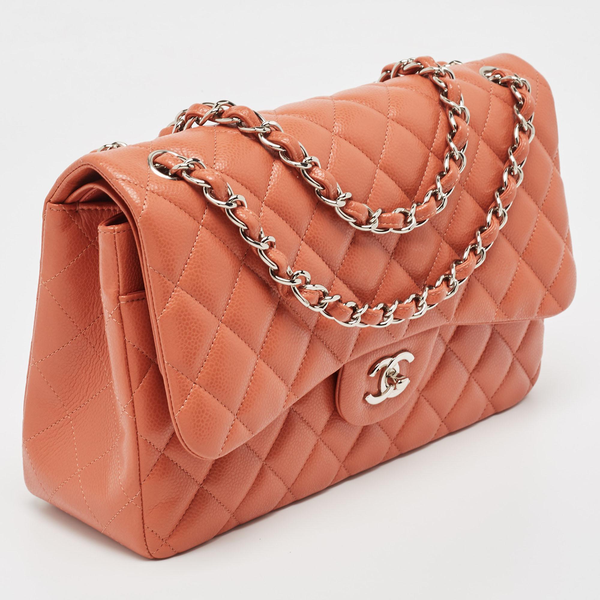 The Chanel Jumbo Classic Double Flap Bag exudes timeless elegance. Crafted from luxurious caviar leather, its quilted pattern adds texture. The spacious double flap design and silver-tone hardware complement the rich brick brown hue, creating a