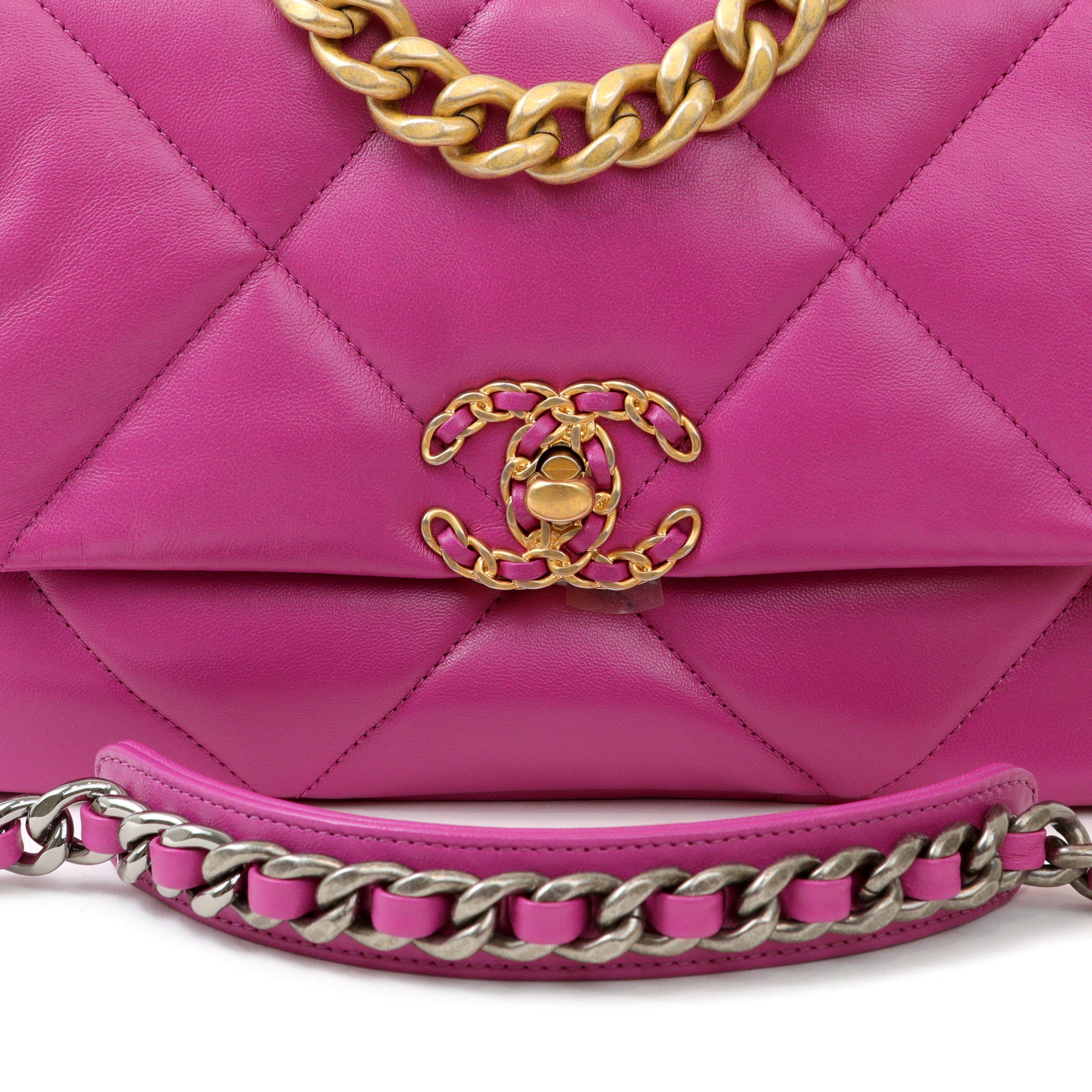 This authentic Chanel Purple Lambskin Small 19 Bag is in pristine condition.  Released in 2019, the pillowy soft oversized quilts and mixed metals are a beautiful addition to the classic flap family.  Bright purple lambskin is quilted in signature