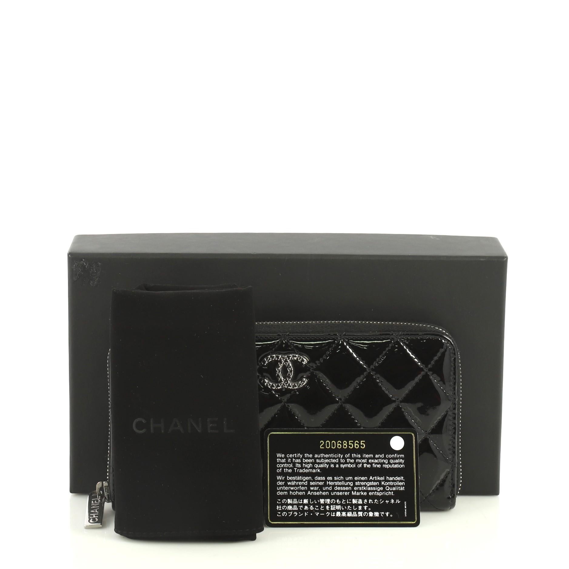 This Chanel Brilliant Zip Around Wallet Quilted Patent Long, crafted from black quilted patent leather, features textured CC logo and silver-tone hardware. Its zip-around closure opens to a black leather interior with multiple card slots, center zip