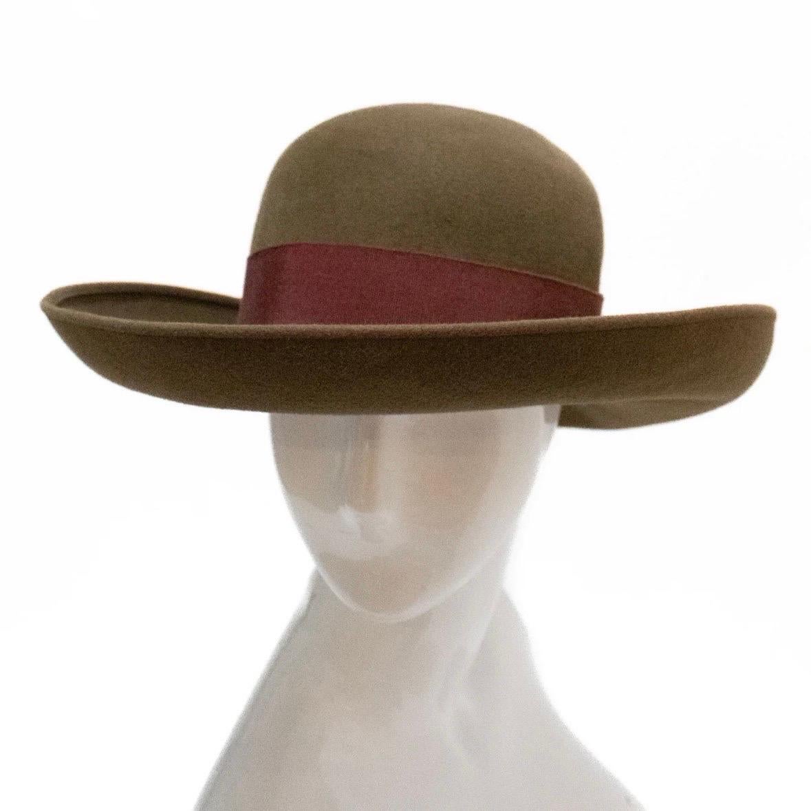 Broad-brimmed hat by Chanel
Made in France
Solid brown
Burgundy red grosgrain ribbon
Fur felt composition
Unworn with original style tag; near perfect with subtle signs of aging
Chanel Style/Model: 511005427084; color: 6040
Dry clean