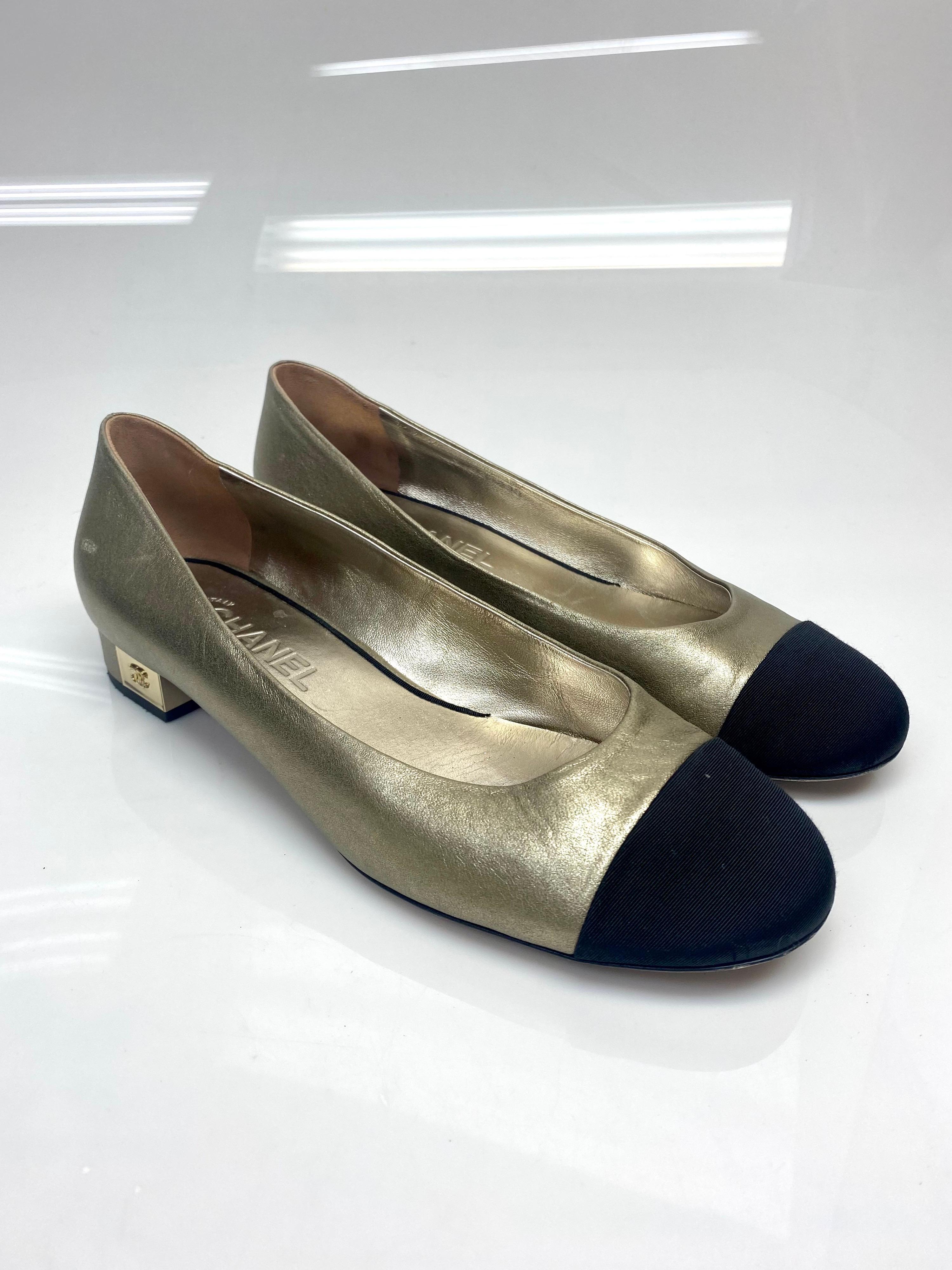 Chanel Bronze and Black Ballerina Pumps with Gold CC Detail Size 40.5. Beautiful Chanel two-toned bronze and black toe cap ballerina pumps. Featuring a black Silk Faille for the toe cap and a beautiful gold leather on the remainder of the shoe