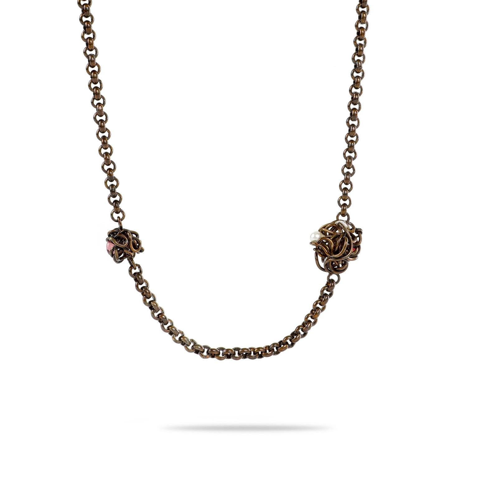 This authentic Chanel Bronze Bird’s Nest Necklace is in excellent condition.  Uniquely finished with a bronze patina, this long necklace is adorned with mini nests.  Each cradling its own glass gemstone “egg.”  Box or pouch included.

PBF 12391