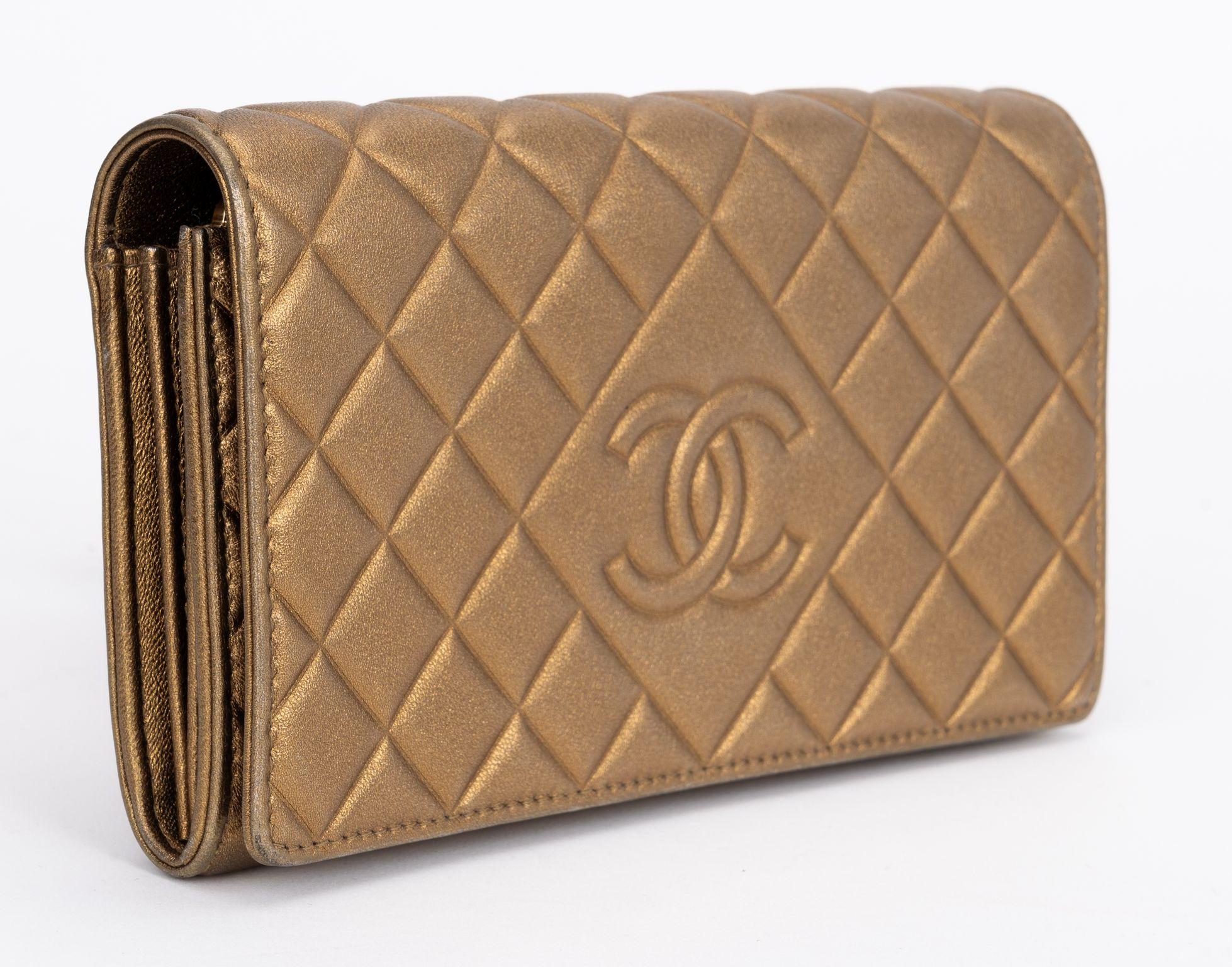Chanel excellent condition bronze leather quilted large wallet, multiple cards slots and center zipped compartment. Collection 21. Comes with hologram and original dust cover.