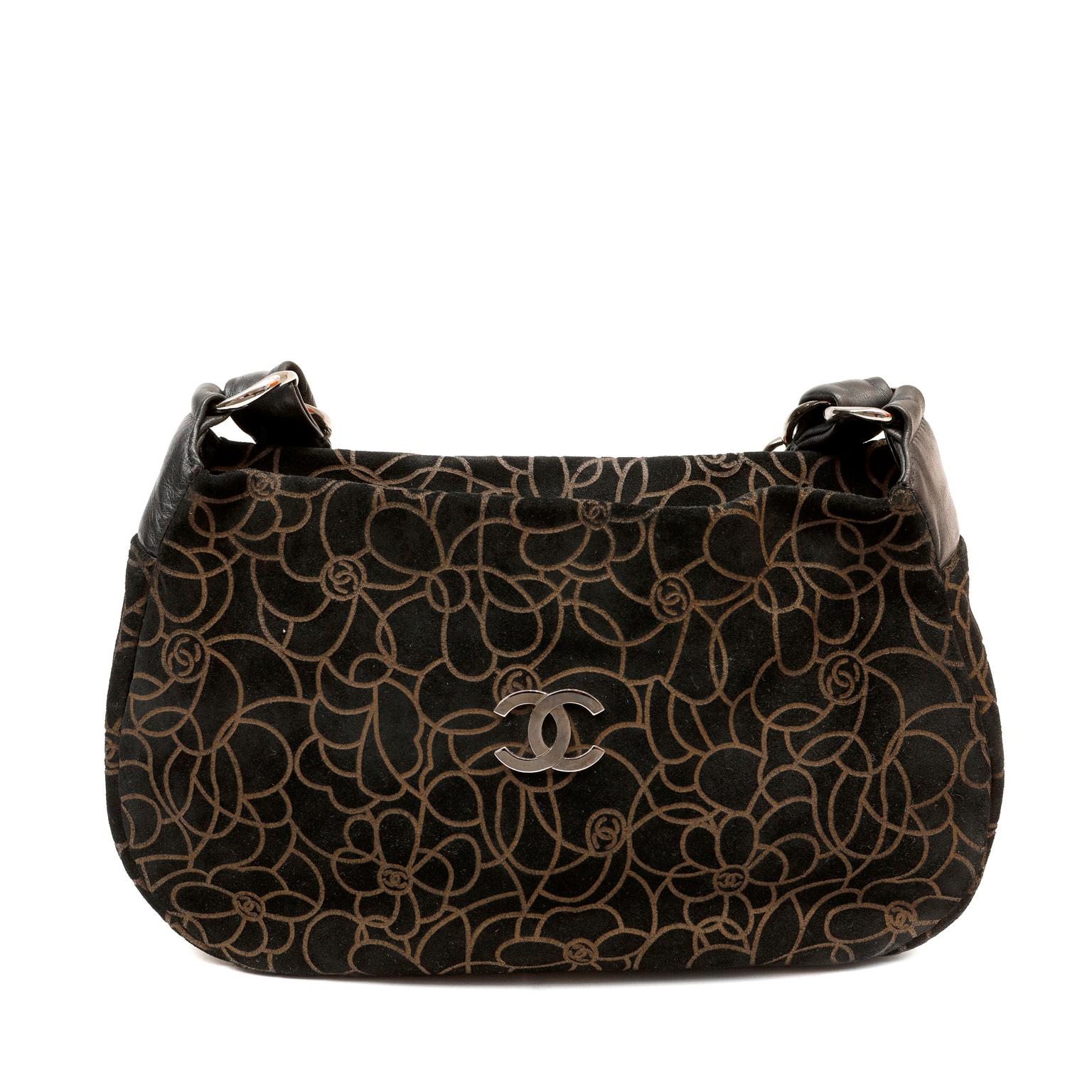 This authentic Chanel Brown and Black Embossed Camellia Bag is in excellent plus condition.  Suede zipper top shoulder bag is embossed with swirling camellia flower pattern and cc logos.   Top zipper closure with clean monogram fabric interior.