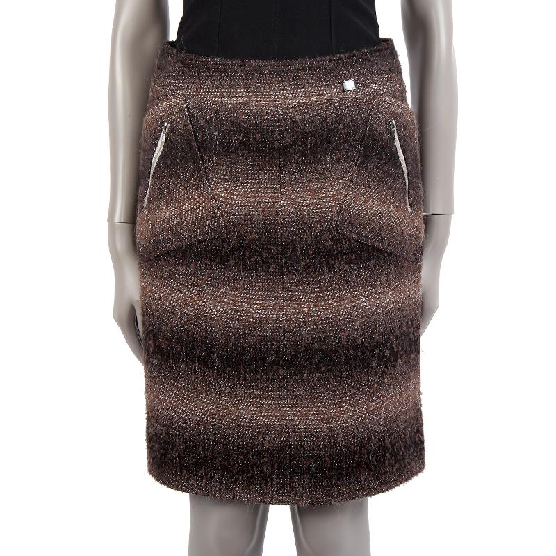 100% authentic Chanel boucle knee-length skirt in gradient brown, black and lurex acrylic (60%), rayon (16%), polyester (8%), nylon (8%), mohair (4%), and wool (4%). With two front patch pockets with silver zippers. Closes with invisible back