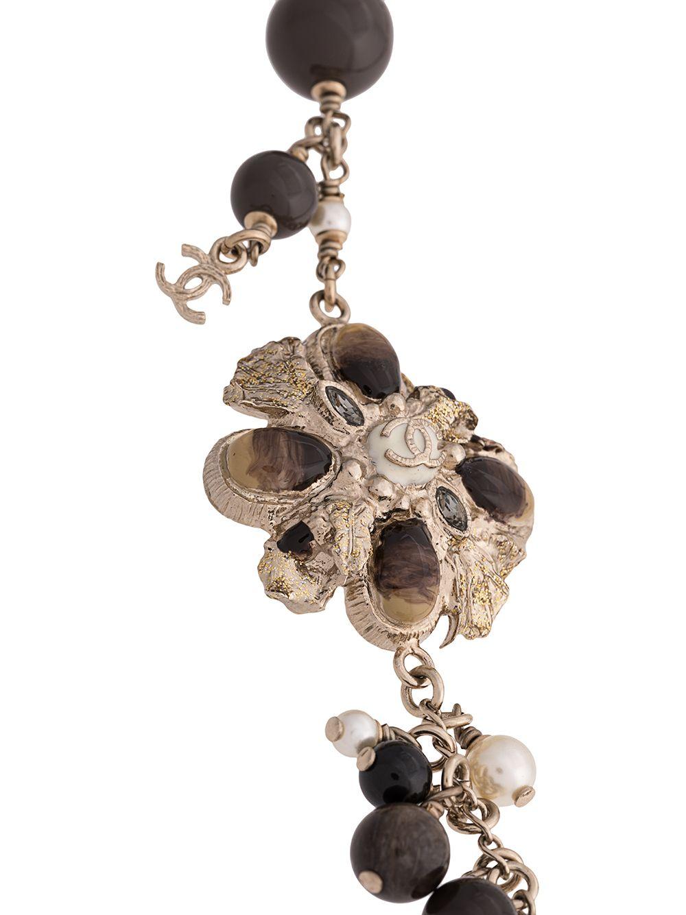 Crafted in France, this elegant, pre-owned necklace from Chanel is a unique piece that adds a touch of classic sophistication to any outfit and features an intricate combination of silver-toned metal hardware, natural coloured stones, glass beads