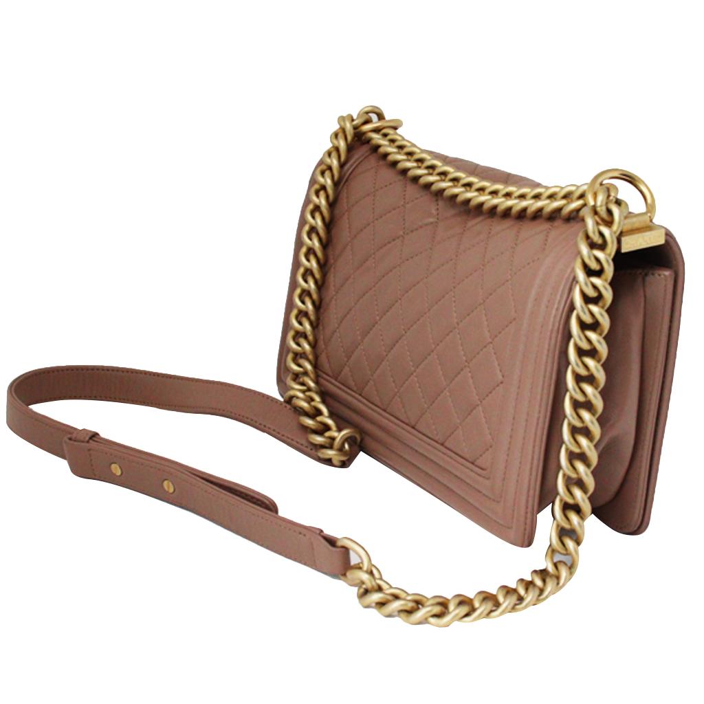 Brand: Chanel
Model: Brown Lambskin Boy Bag
Size: Medium
Color: Brown
Style: Shoulder Bag
Date Code: 24770663
Materials: Quilted lambskin leather
Strap: Brown Lambskin strap with gold tone braid
Hardware: Gold hardware
Measurements: Length: 9.75