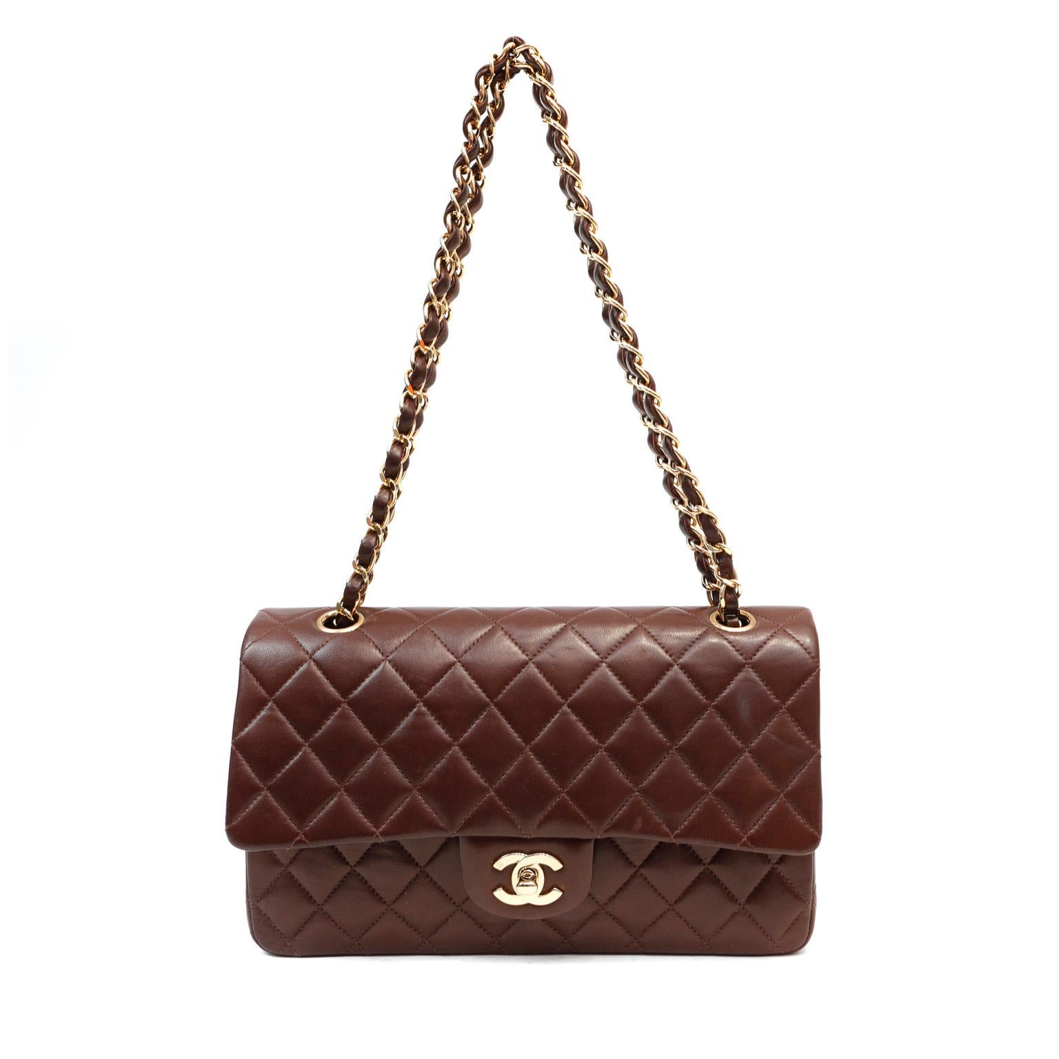 This authentic Chanel Brown Lambskin Medium Classic Double Flap Bag is in pristine condition.  Most commonly seen in black, this rare chocolate brown version is exquisite and perfectly scaled in the medium silhouette.

Rich chocolate brown lambskin