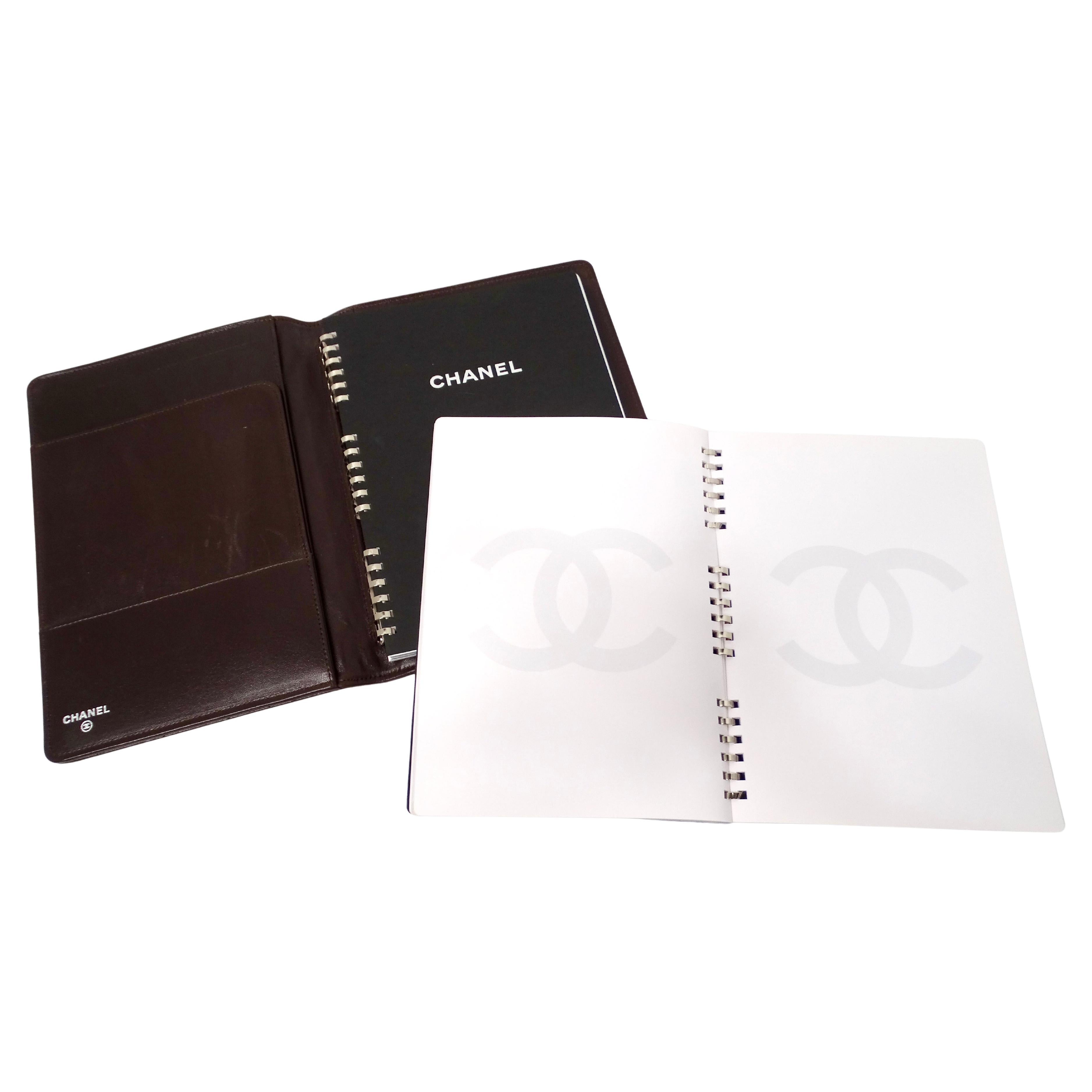 The Chanel Brown Lambskin Quilted Leather Notebook Agenda Cover is a sophisticated and luxurious accessory, perfect for those who appreciate timeless elegance. Crafted from plush lambskin leather, this notebook cover features Chanel’s iconic