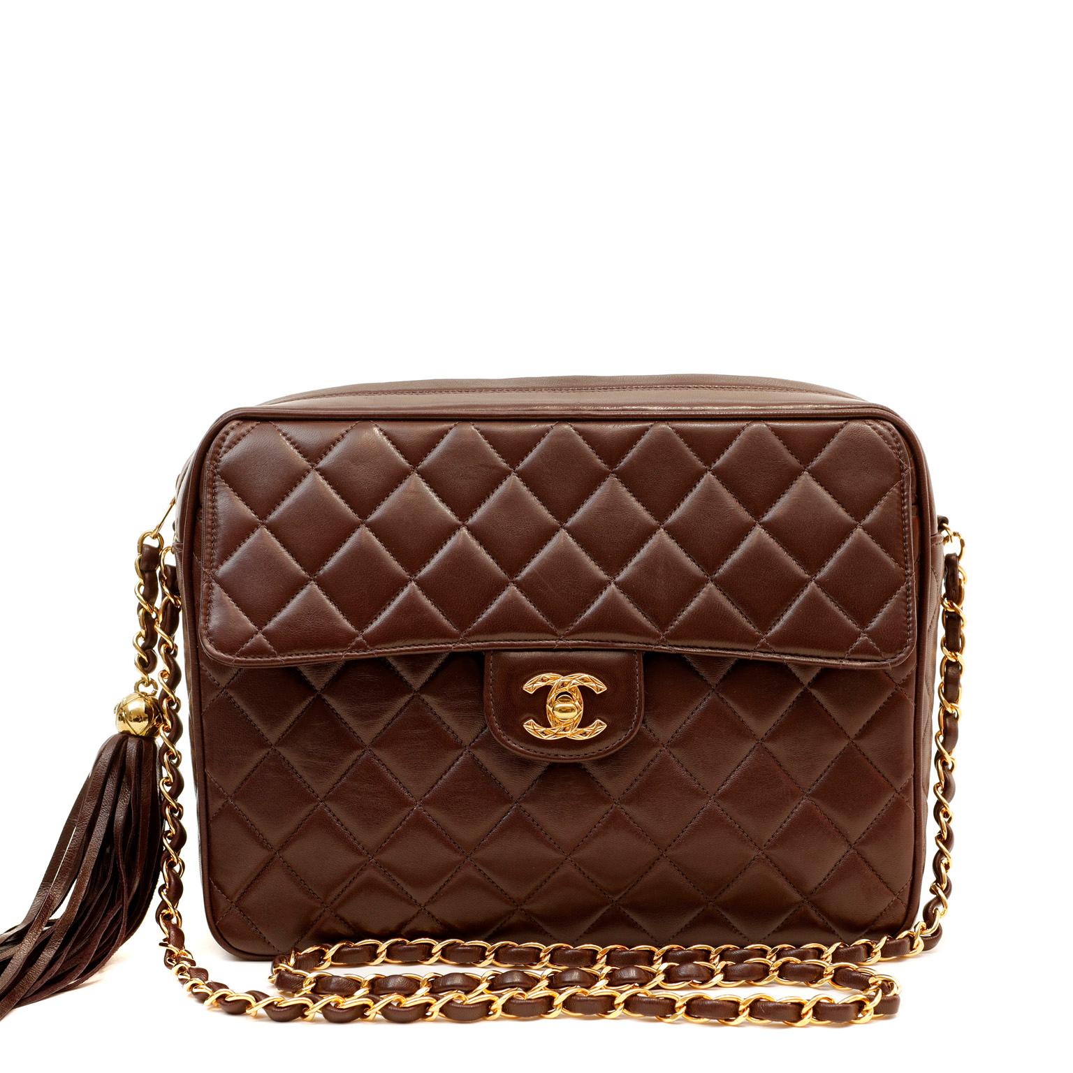 This authentic Chanel Brown Lambskin Vintage Camera Bag is in excellent plus condition.  A beautiful timeless classic, this is a must have for any collection. Rich chocolate brown lambskin is quilted in signature Chanel diamond pattern.  Gold