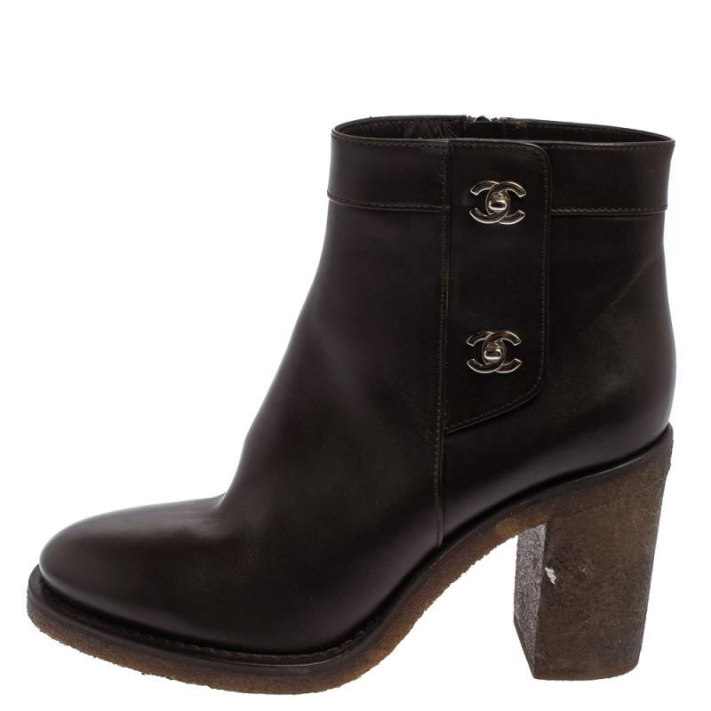 Add a high-end update with these ankle boots from Chanel. Crafted from leather, these brown boots feature round toes, CC turn-lock detailing, and zip closure. Elevated on block heels, the insoles are luxuriously lined with leather.

