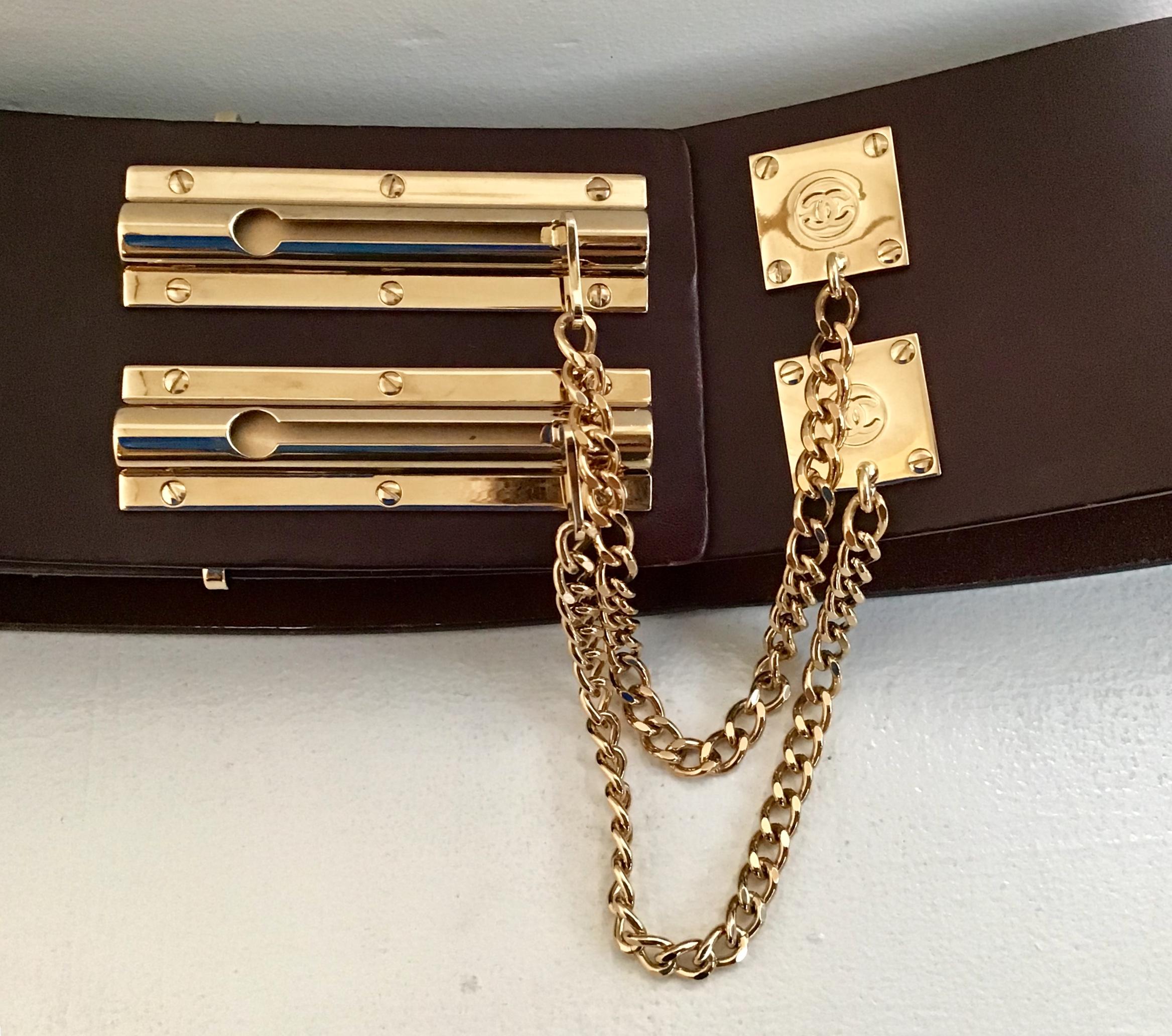 Chanel Brown Leather Sliding Chain Lock Belt. Featuring two gold toned sliding chain locks with Chanel logo. Size 38.
