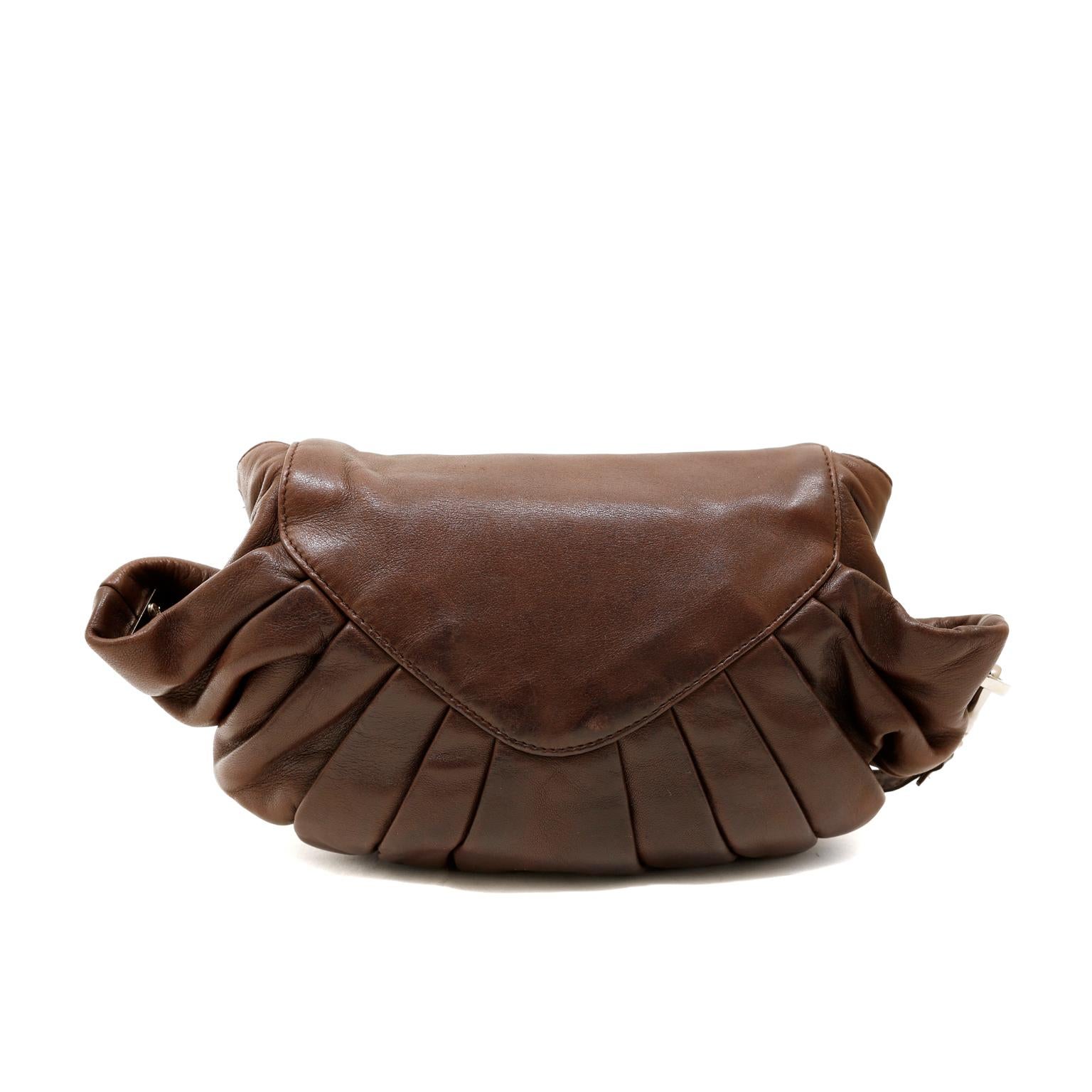 This authentic Chanel Brown Pleated Lambskin Flap Bag is in very good condition.  The unique silhouette and gathered details make this Chanel a standout piece in any collection.  
Rich brown lambskin bag has a rounded bottom with pleated folds. 
