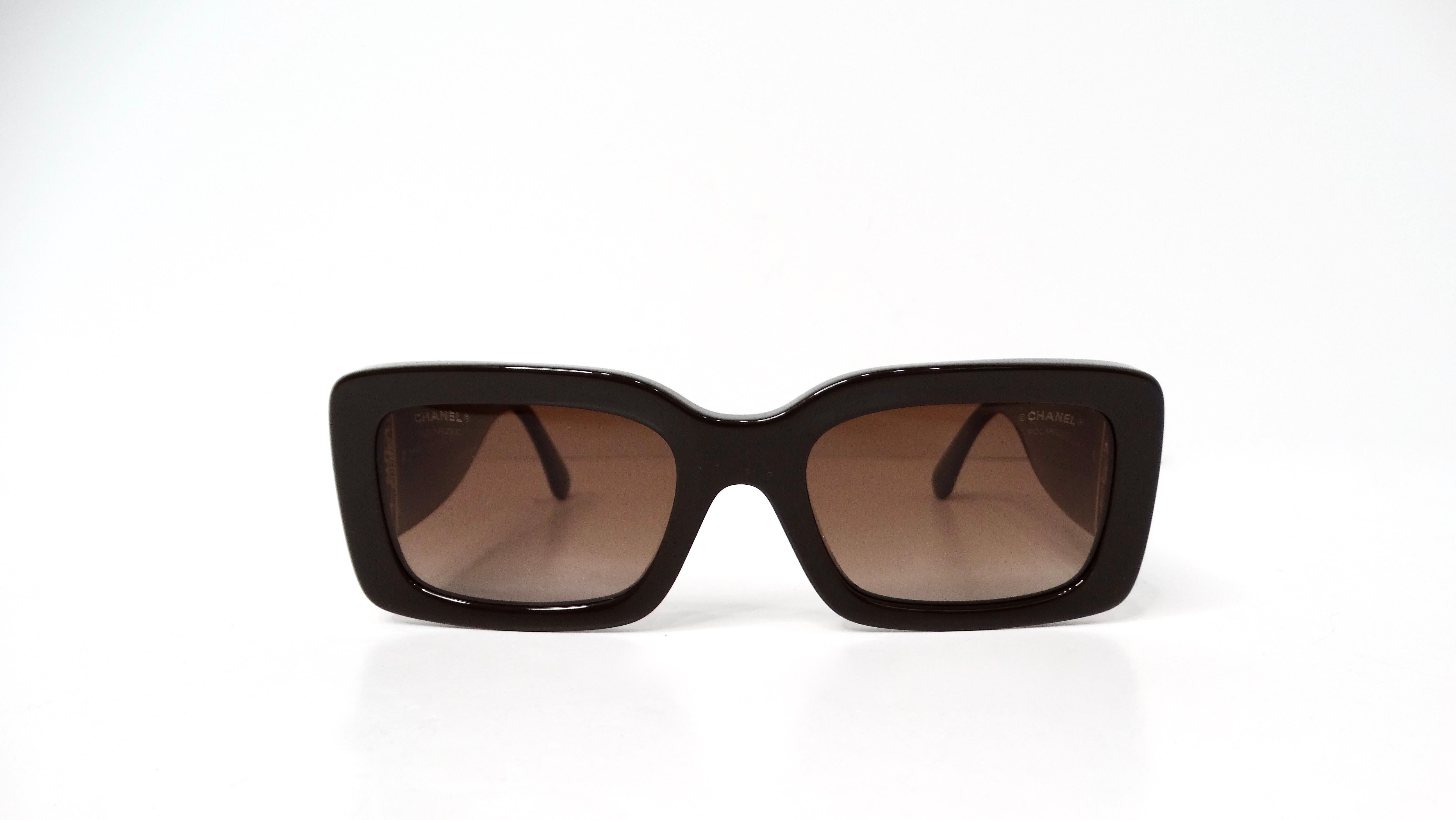 Introducing the Chanel Brown Rectangular Gold-Tone Interlocking CC Accent Sunglasses, a luxurious accessory that effortlessly elevates any outfit. These stunning tinted polarized sunglasses feature a chic rectangular shape, complemented by the