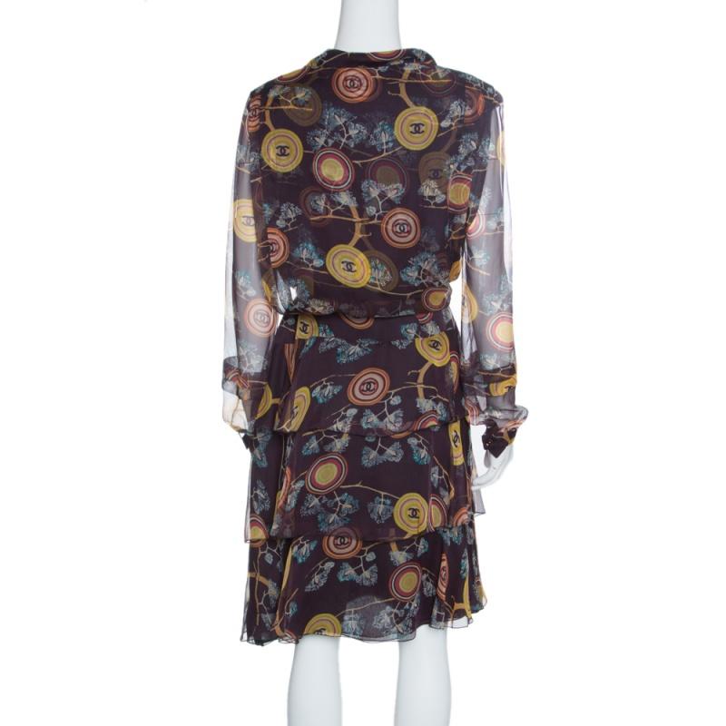 Granting a flattering and feminine silhouette, this dress from the Spring 2001colllection of Chanel is a melange of label's elegant aesthetics and coquettish details. It is cut from luxurious silk and features a beautiful floral print along with CC