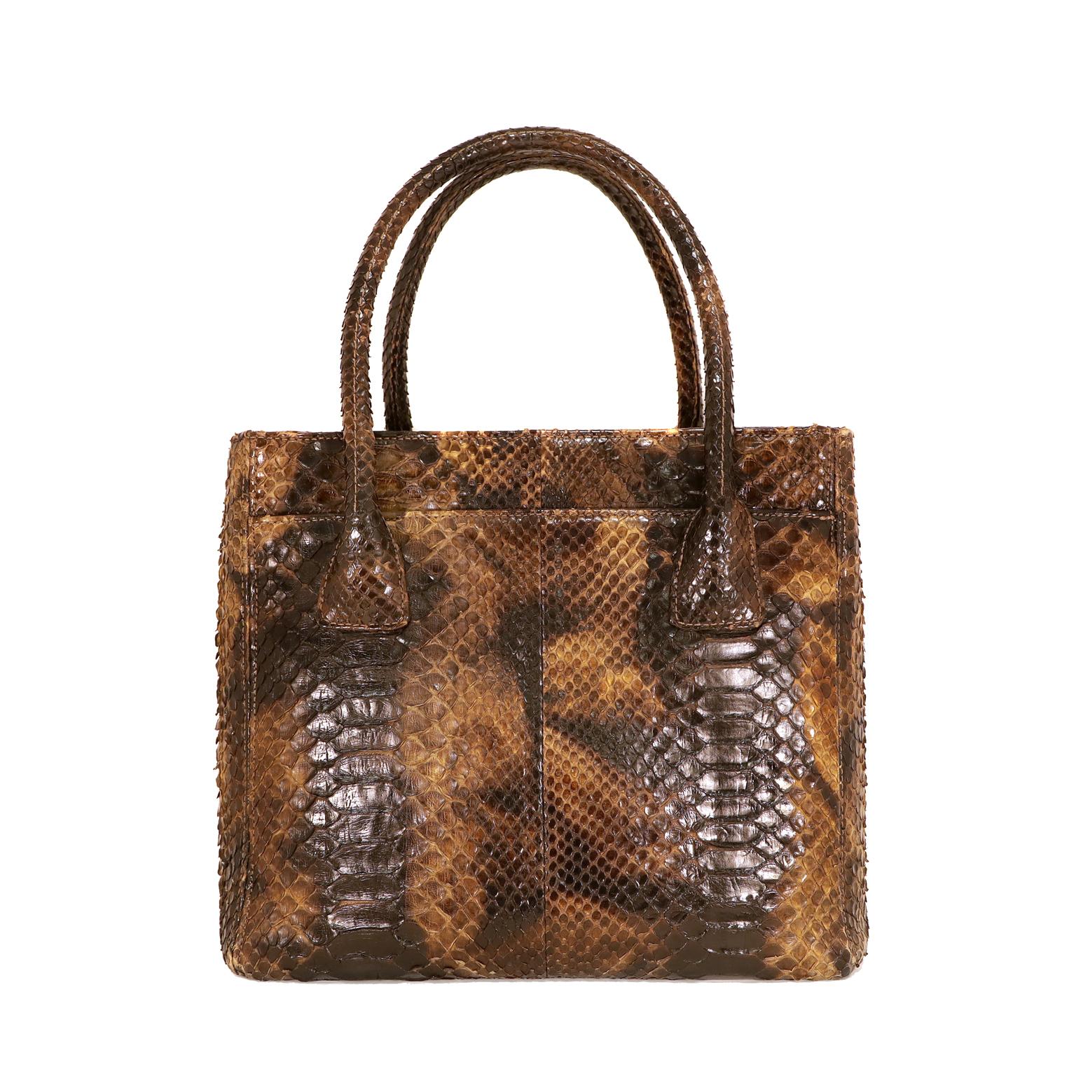This authentic Chanel Brown Python Tote is in beautiful condition.  It has enjoyed a previous life and may have light imperfections.  
Multihued brown and tan python tote has ruthenium CC twist lock on a front pocket.  Conveniently divided into