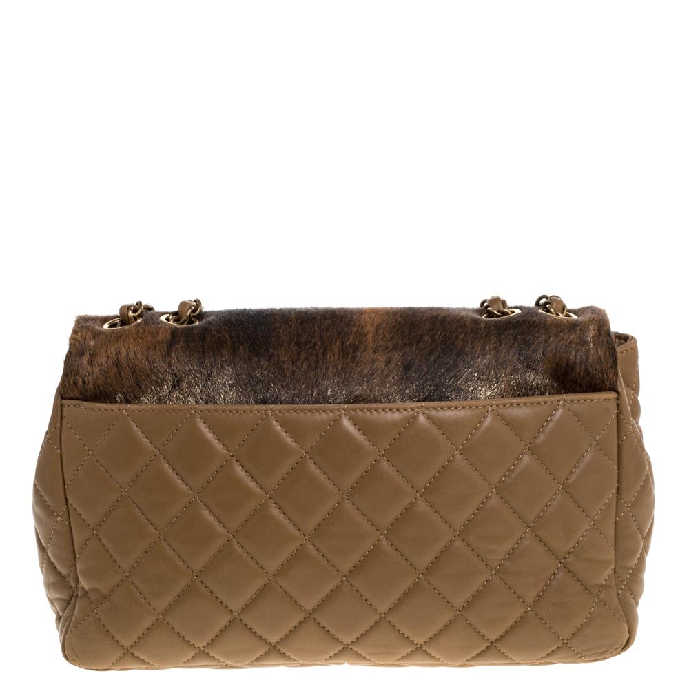 We are in utter awe of this flap bag from Chanel as it is appealing in a surreal way. Exquisitely crafted from leather & calfhair with a quilt design on the sides, it bears their signature label on the satin interior and the iconic CC turn-lock on