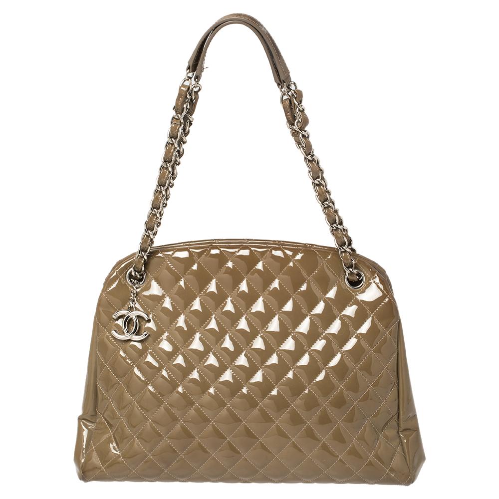 This Just Mademoiselle Bowler bag from Chanel is full of charm and elegance. It has been crafted from quilted patent leather and features a lovely shape and design. It is equipped with two chain handles and well-sized fabric compartments to keep