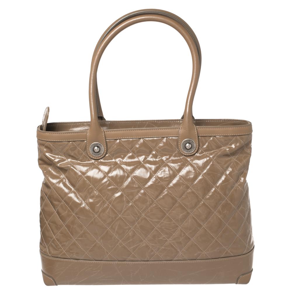 Chanel bags are every girl's dream and this one is a must-have. It's crafted from striated quilted canvas and leather. It comes with two handles and the signature interlocking CC charm. The interior is lined with fabric and has one zipper