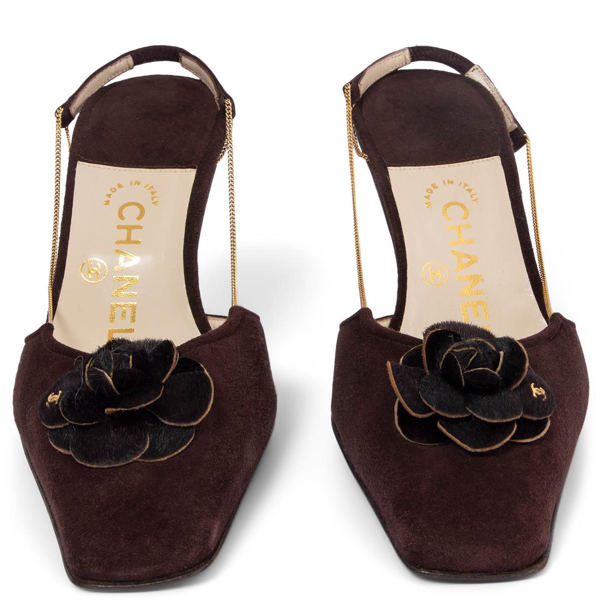 100% authentic Chanel vintage slingback pumps in brown suede embellished with calf-hair Camellia and gold-tone chain straps. Brand new. 

Measurements
Imprinted Size	38.5
Shoe Size	38.5
Inside Sole	26.5cm (10.3in)
Width	7.5cm (2.9in)
Heel	8cm